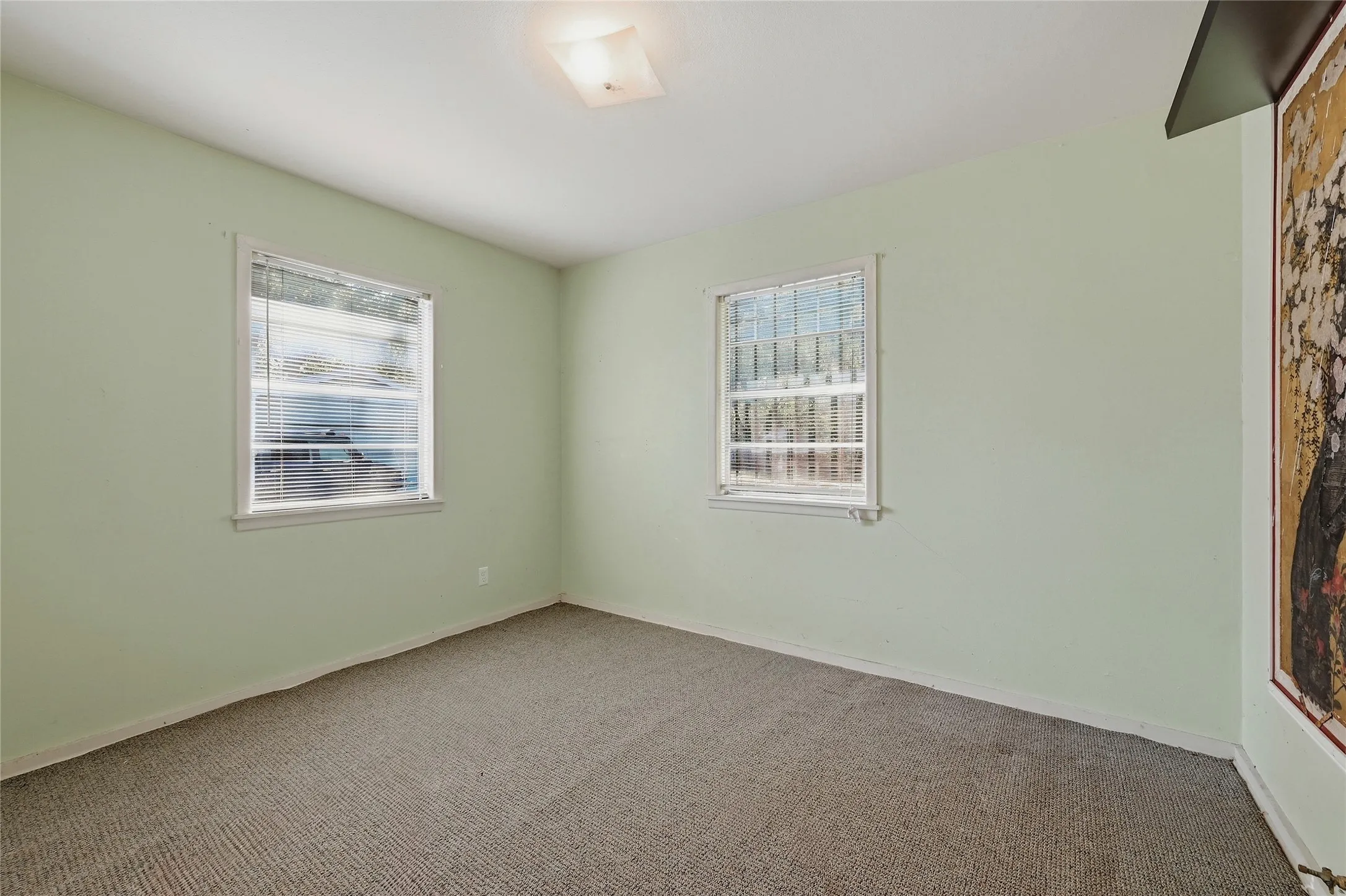 Wall-to-wall carpeting with light-toned walls and two​​‌​​​​‌​​‌‌​‌‌​​​‌‌​‌​‌​‌​​​‌​​ windows