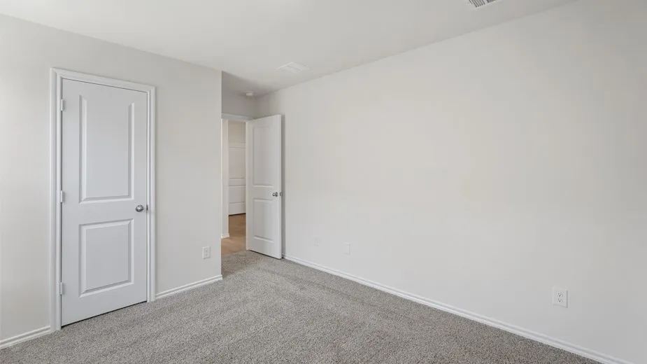 Neutral wall color with a carpeted floor