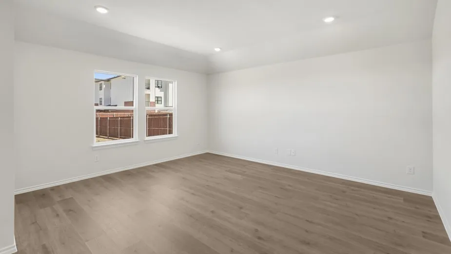 Recessed lighting, light wood-finish flooring, white walls, and a tray ceiling