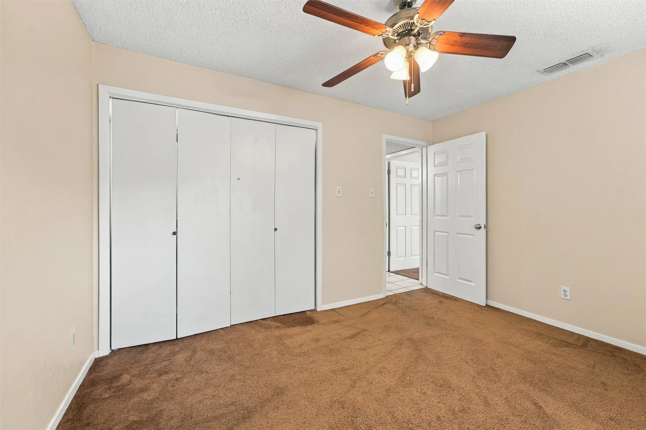 Expansive brown carpeting and light-toned walls