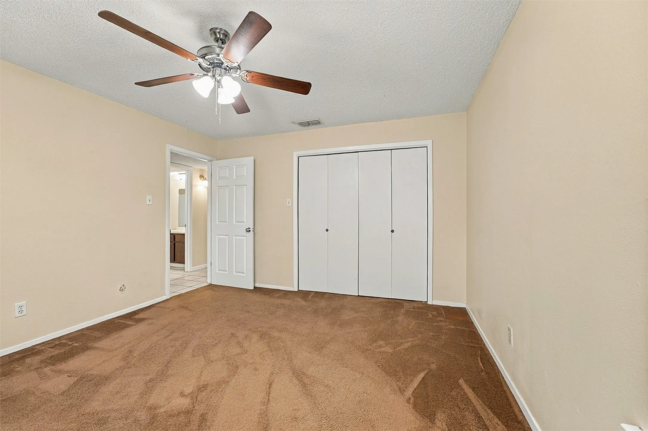 Room featuring brown carpet flooring and light-toned wall paint