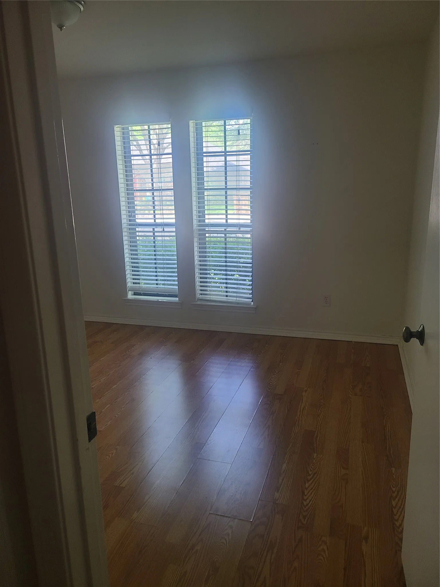 Spacious bedroom with solid surface flooring