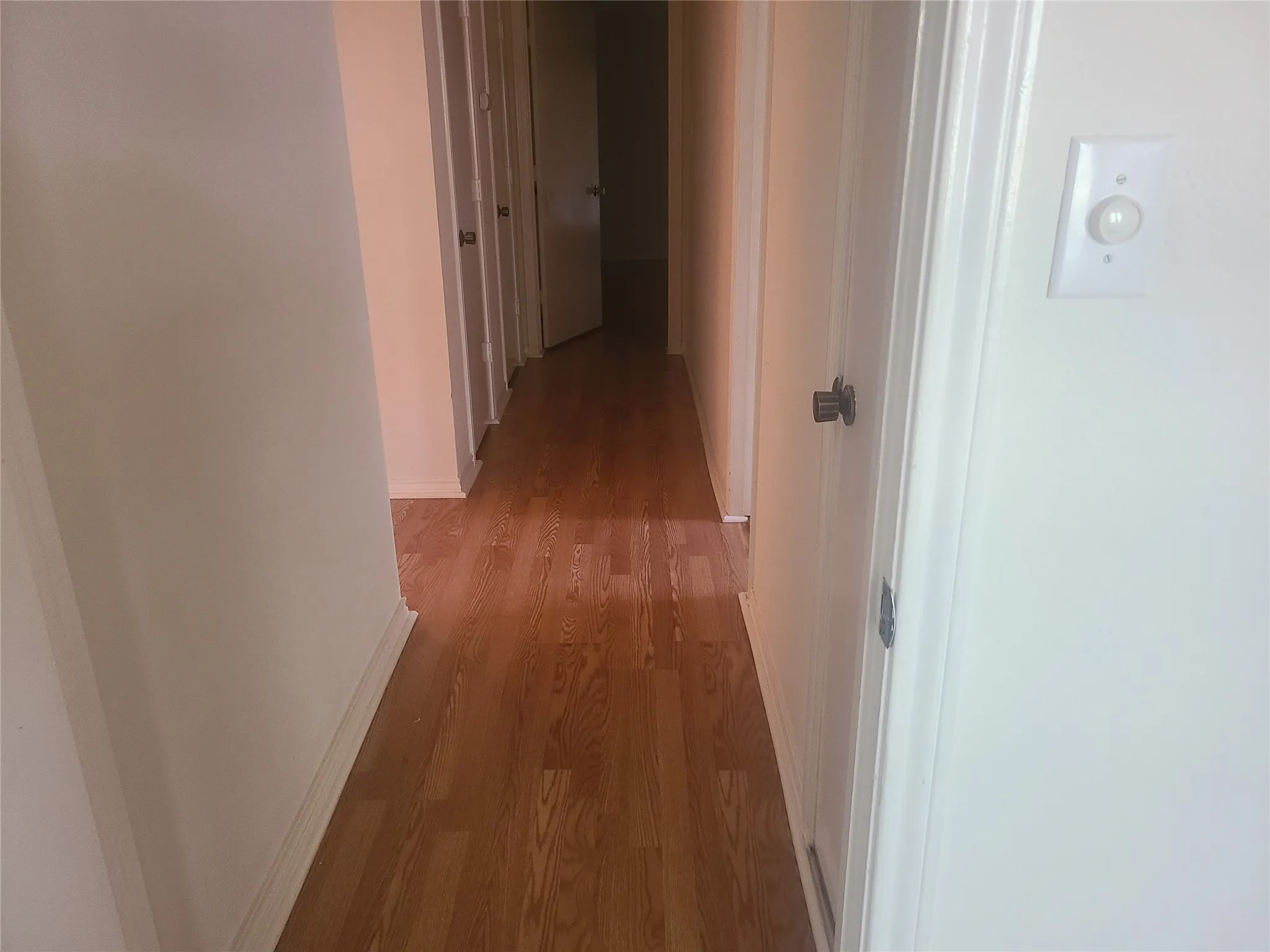 Hallway leading to bedrooms with solid surfact wood laminate flooring
