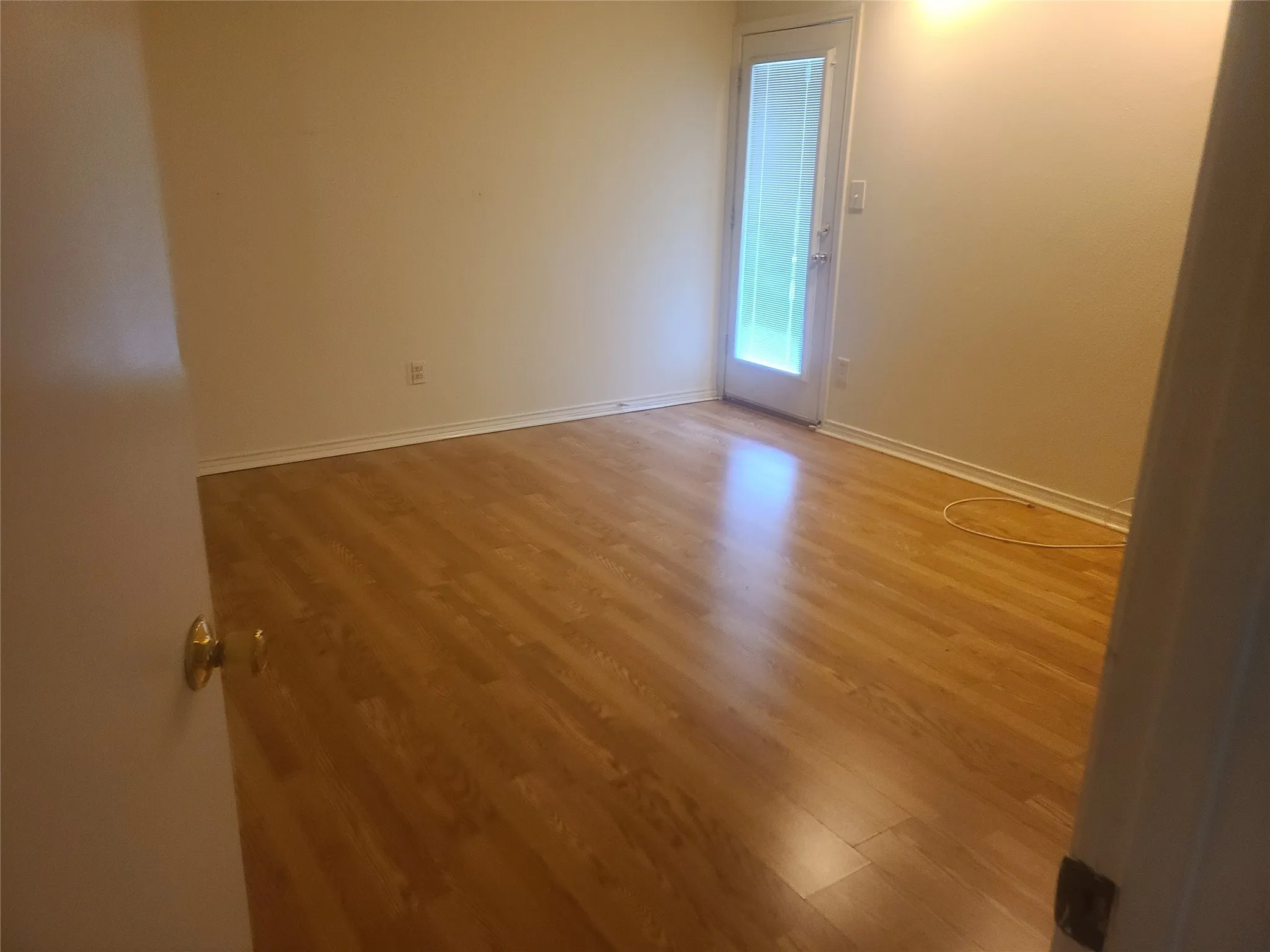 Spacious bedroom with solid surface wood laminate flooring