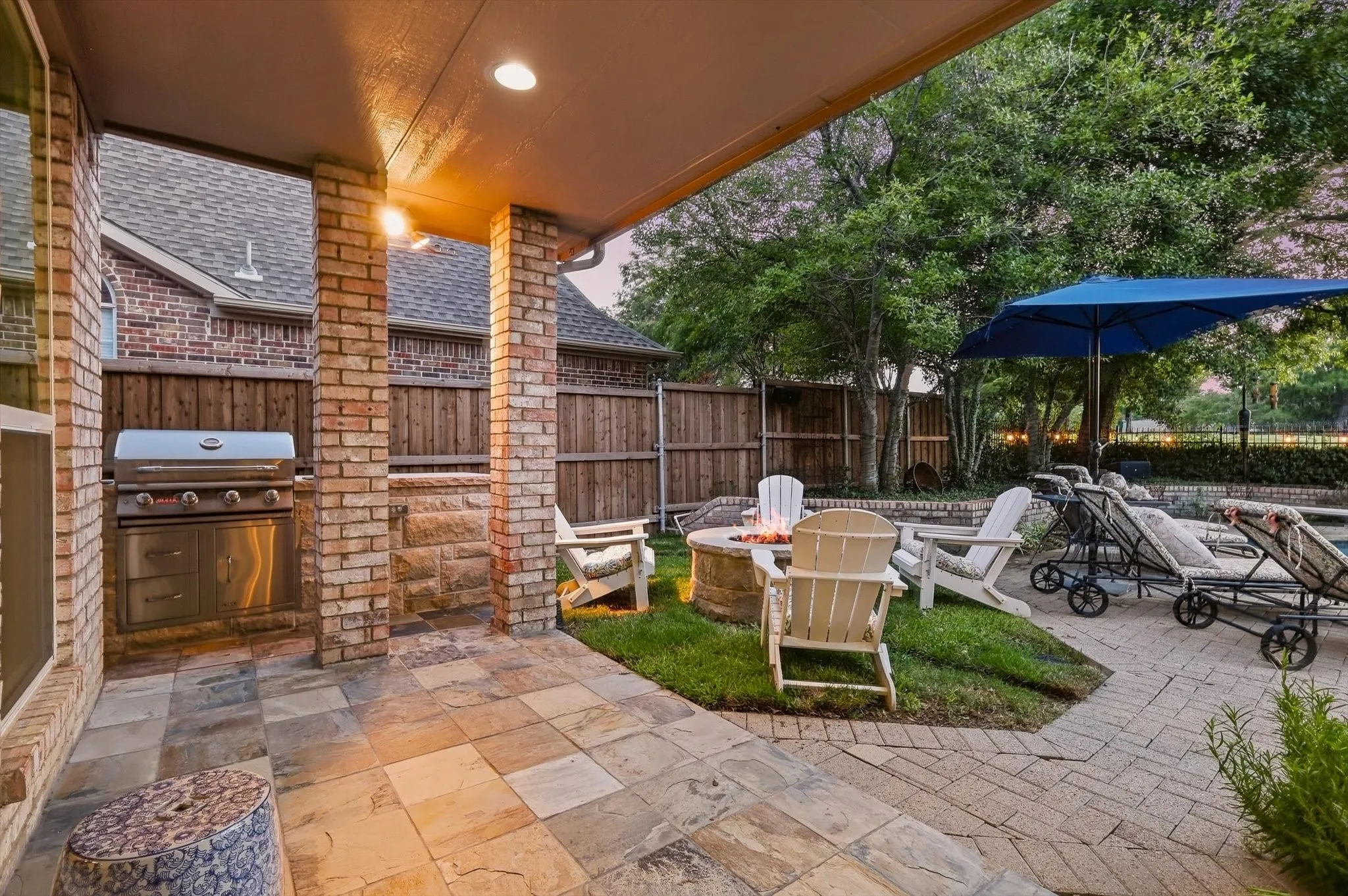 Additional patio space with Built-in stone outdoor kitchen