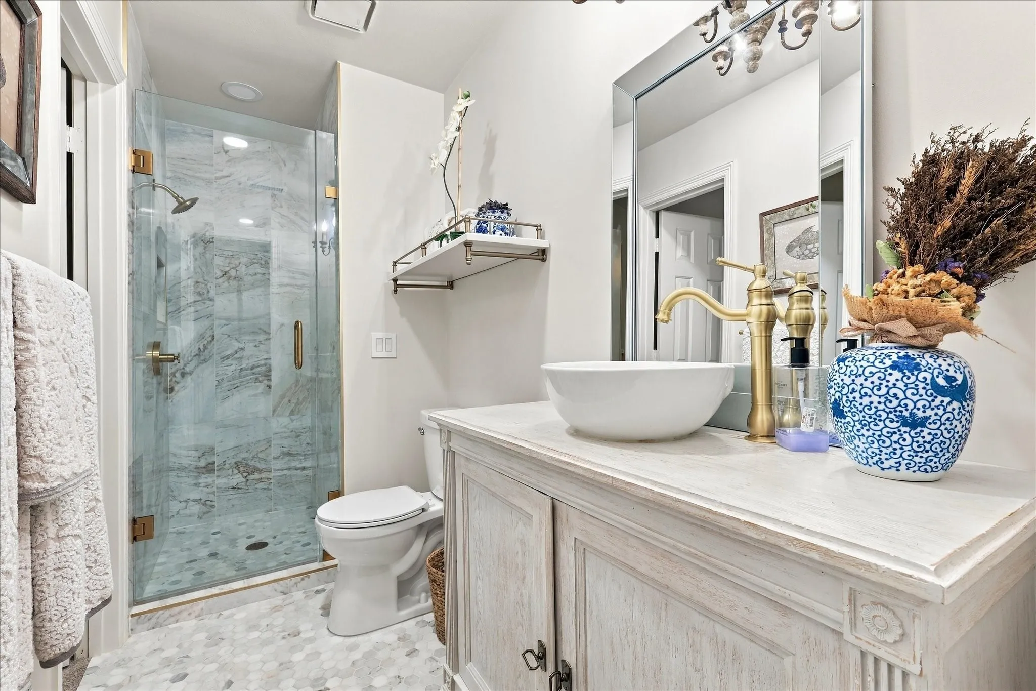 Ensuite for bedroom #3. Totally remodeled with oversized shower, custom cabintry, bowl sink and faucet. Also featuring designer mirror, shelving and hardware.