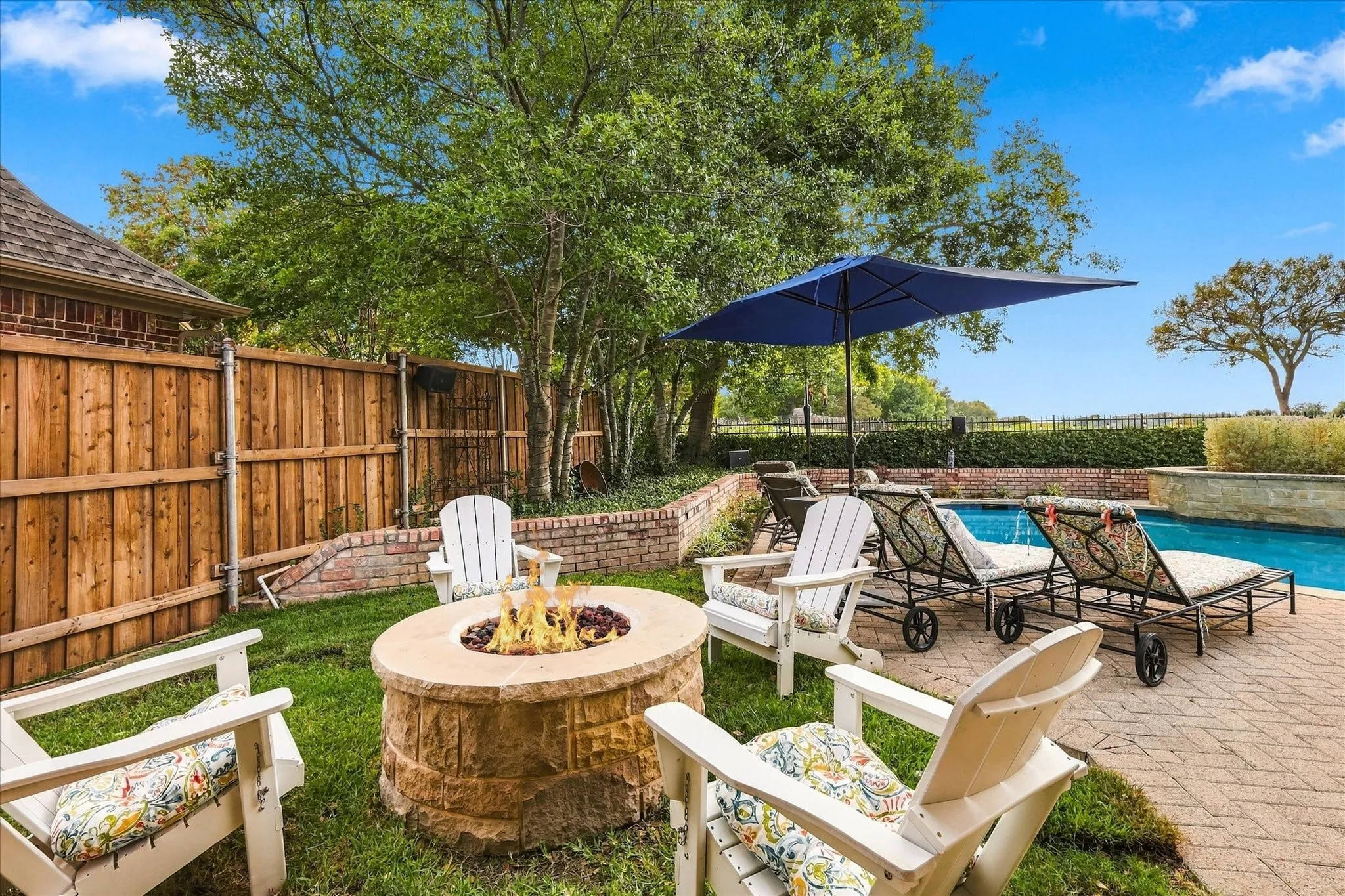 Newly built natural gas stone fire pit situated in backyard area