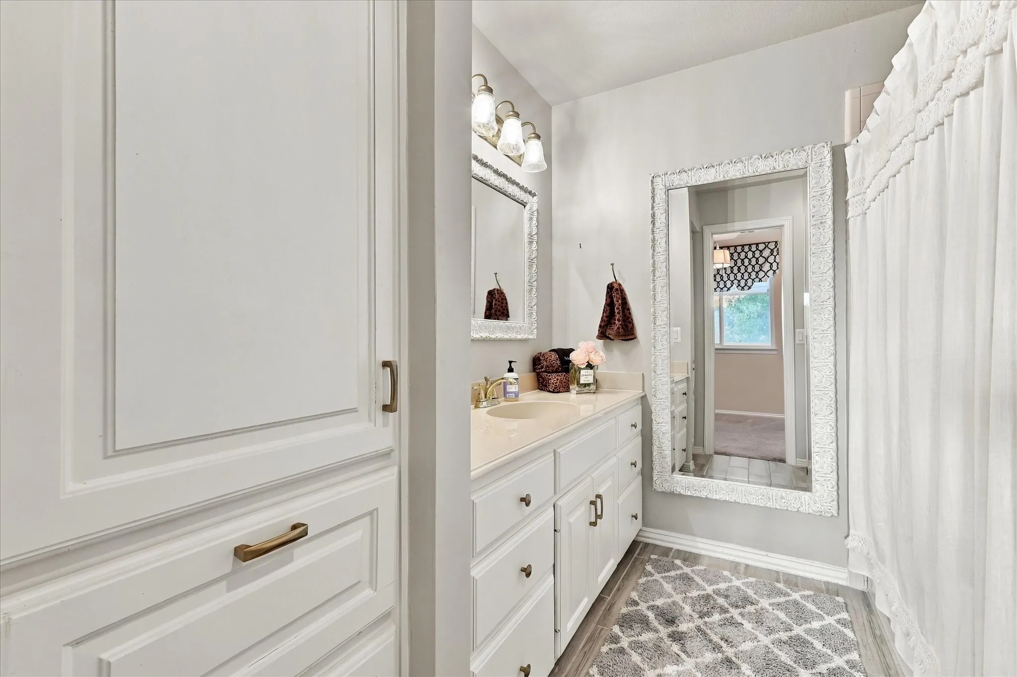 Ensuite for bedroom #4. Bathroom features tub with shower, tile flooring, linen closet and floor length mirror.