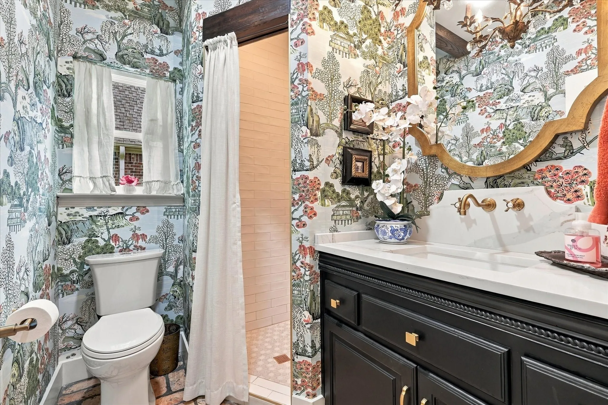 Completely remodeled full bath downstairs adjacent to bedroom. New shower, updated cabinets and counter tops with custom wall covering