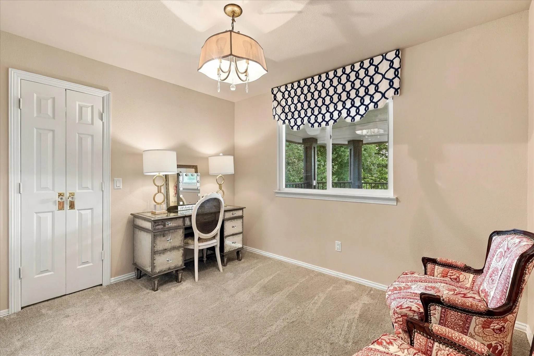 Upstairs bedroom #4 with ensuite. Currently being used as a secondary office and sitting area. This bedroom features updatd lighting, carpet and window treatments.