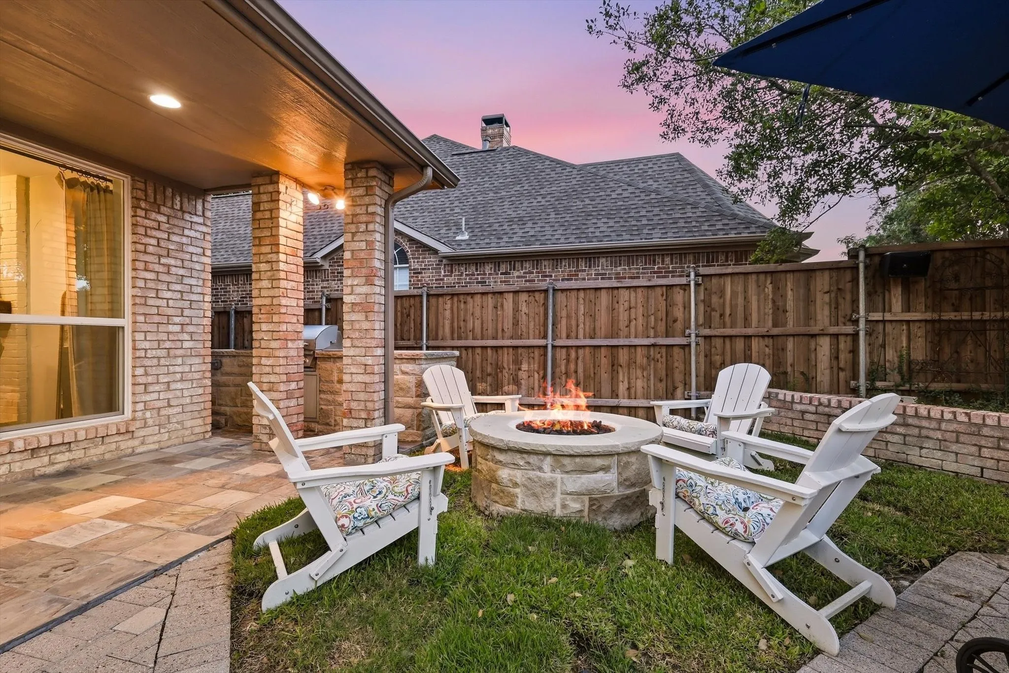 Additional view of firepit and outdoor kitchen