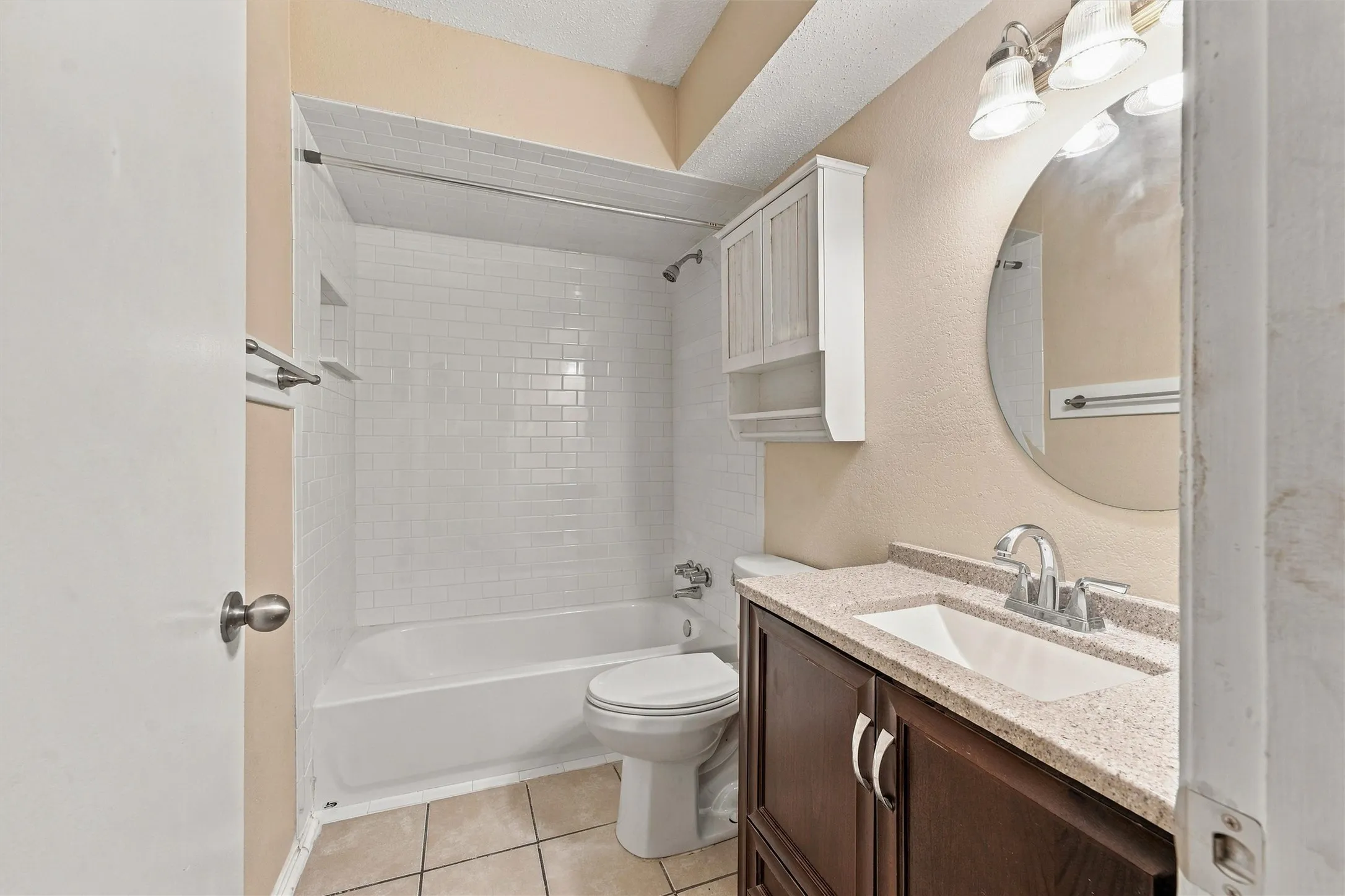 White subway tile shower surround with integrated soap dish