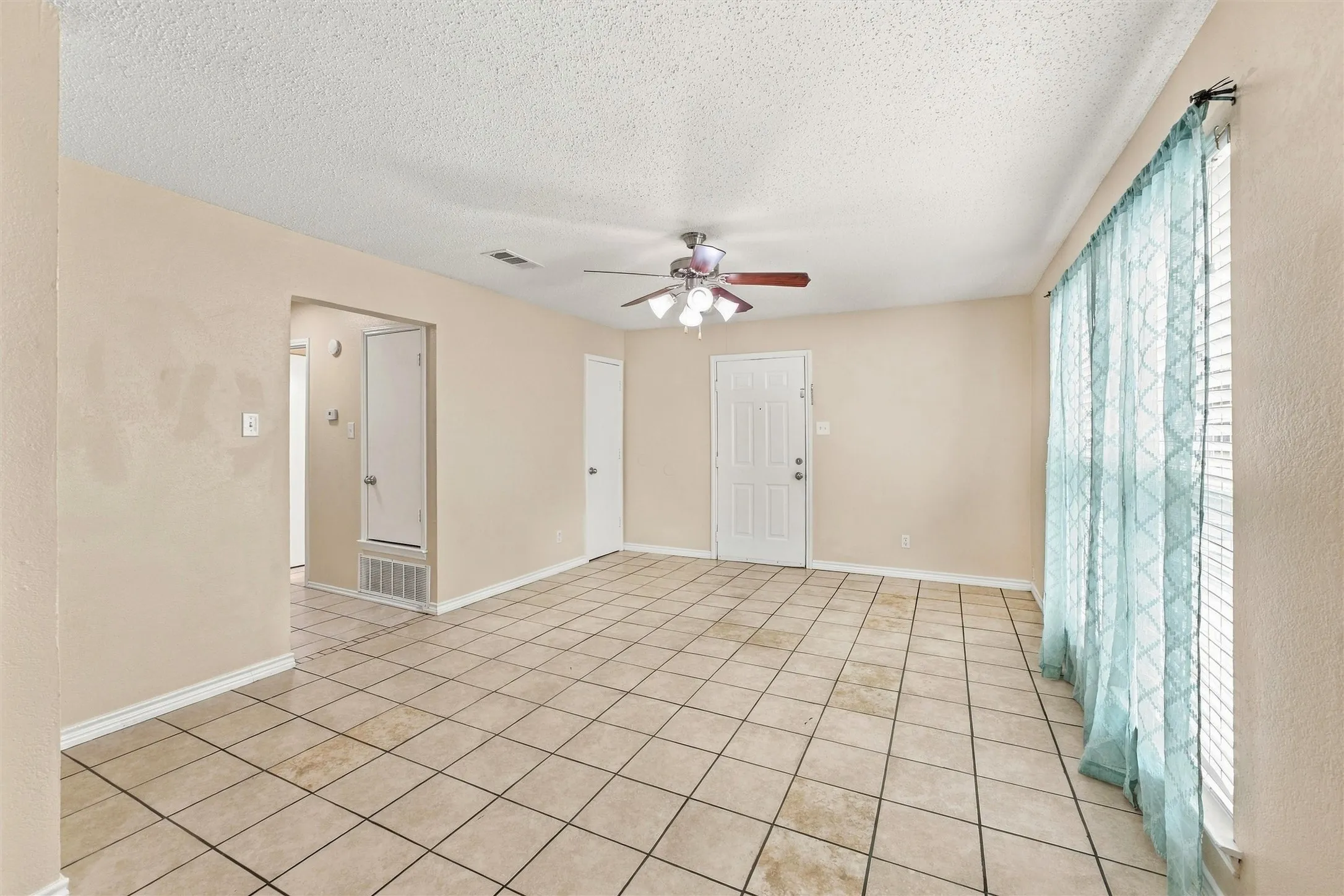 Neutral-toned walls complement the tiled flooring