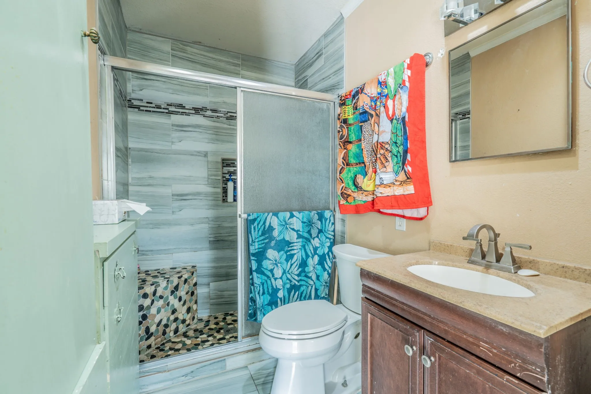 Walk-in shower with tile surround and built-in bench