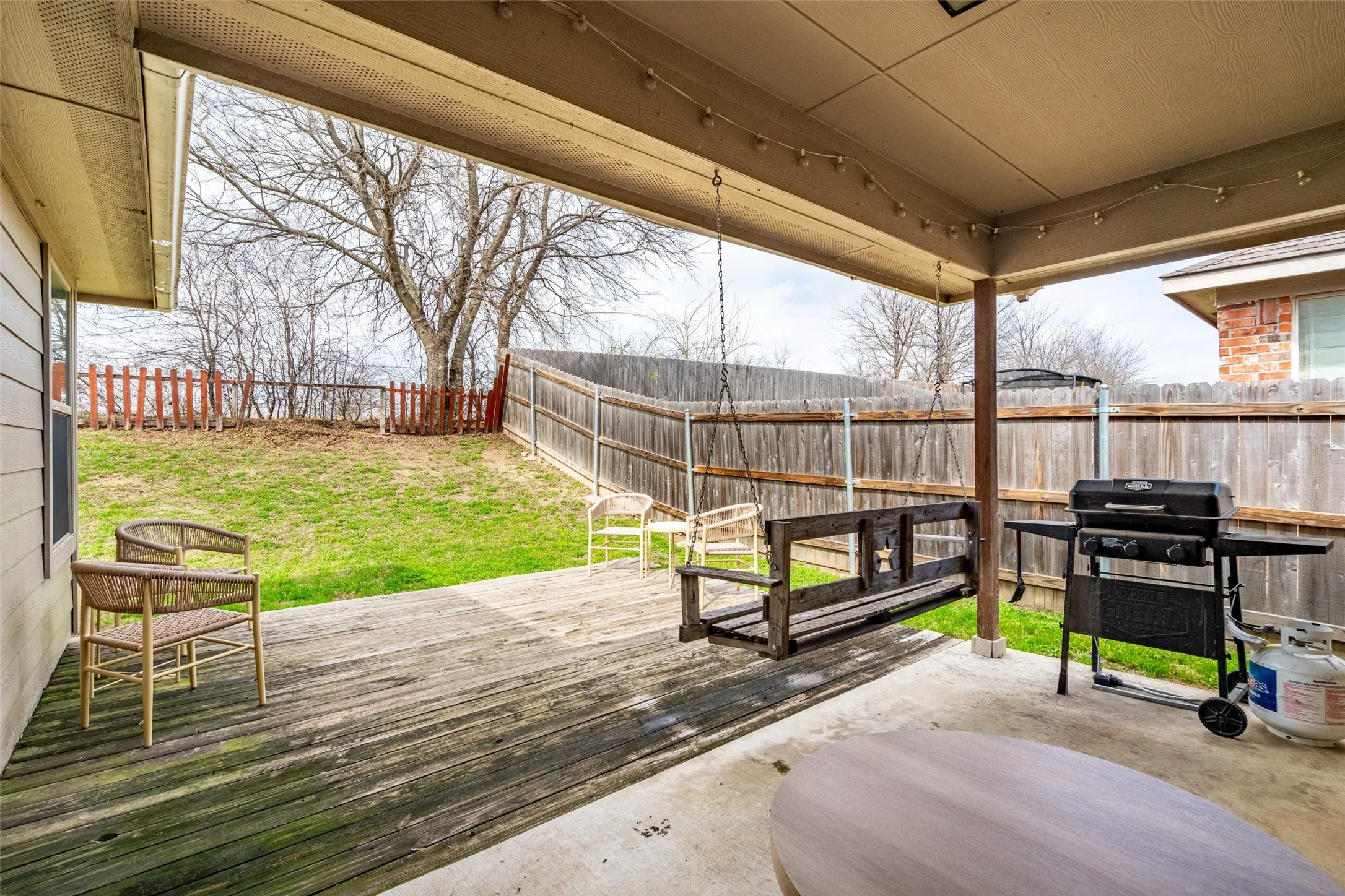 Covered patio featuring a concrete slab and wood deck
