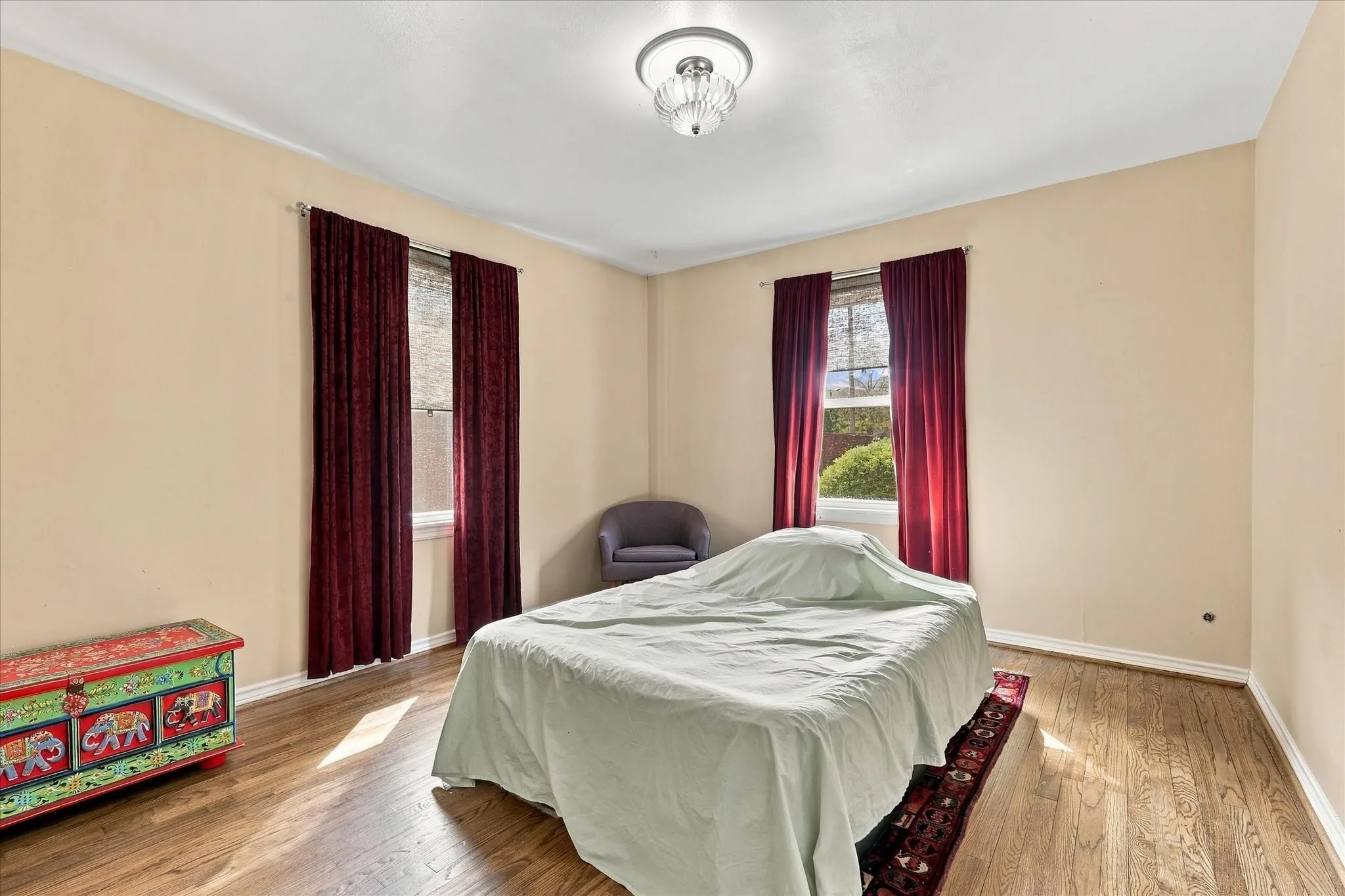 One of two bedrooms with new windows and hardwood floors