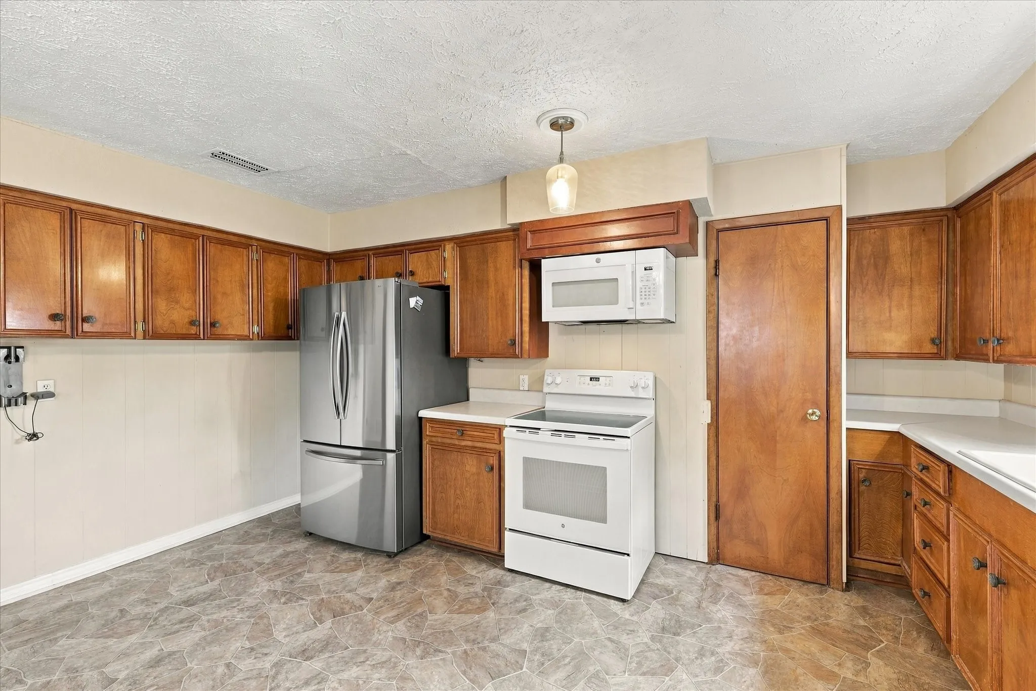 Kitchen has abundant cabinets and open space