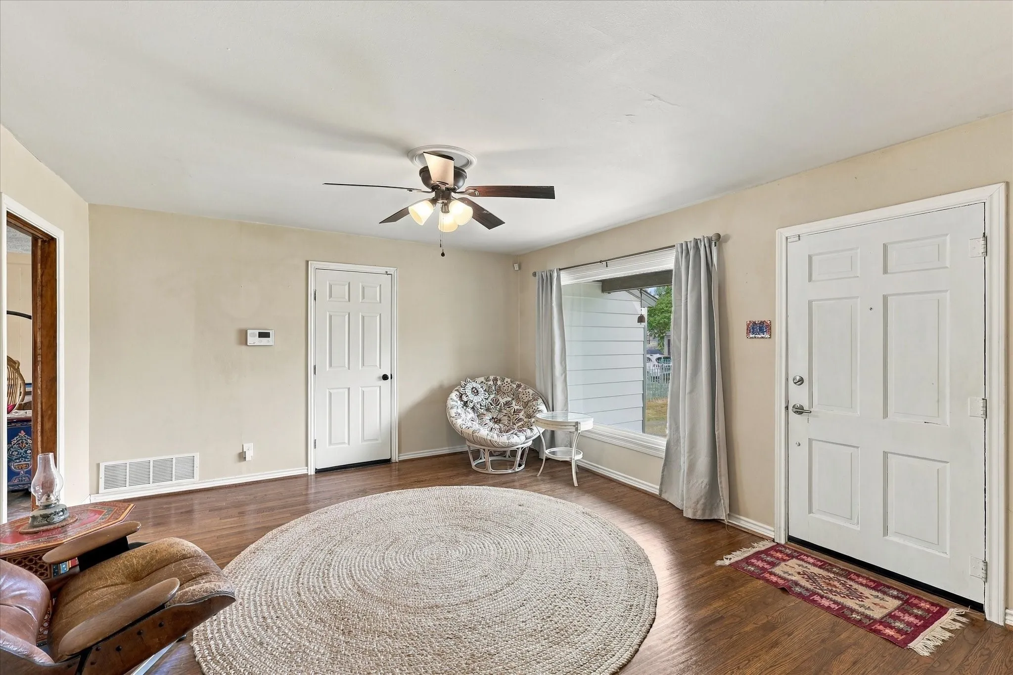 Front room features large picture glass window and hardwood floors
