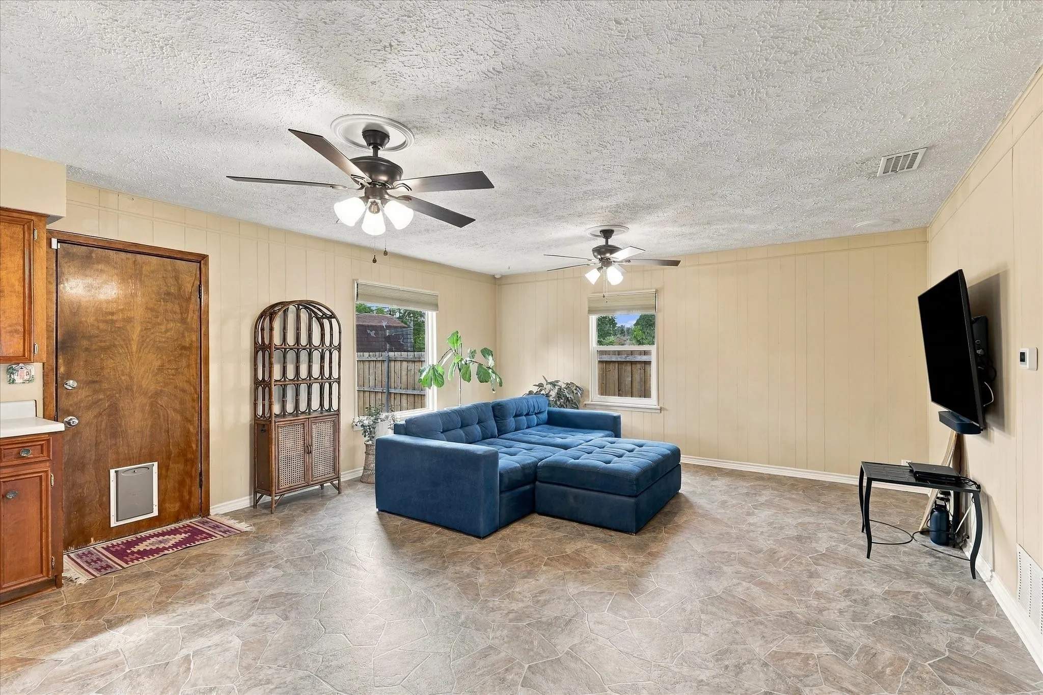 Large open family room with door to backyard