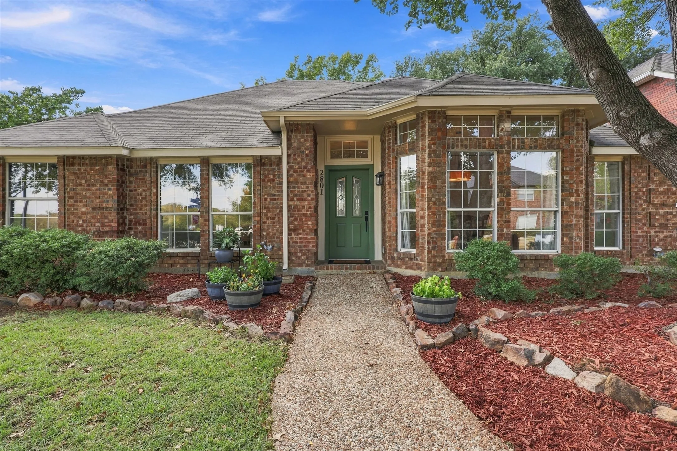 Brick exterior with a gabled roof and bay window
