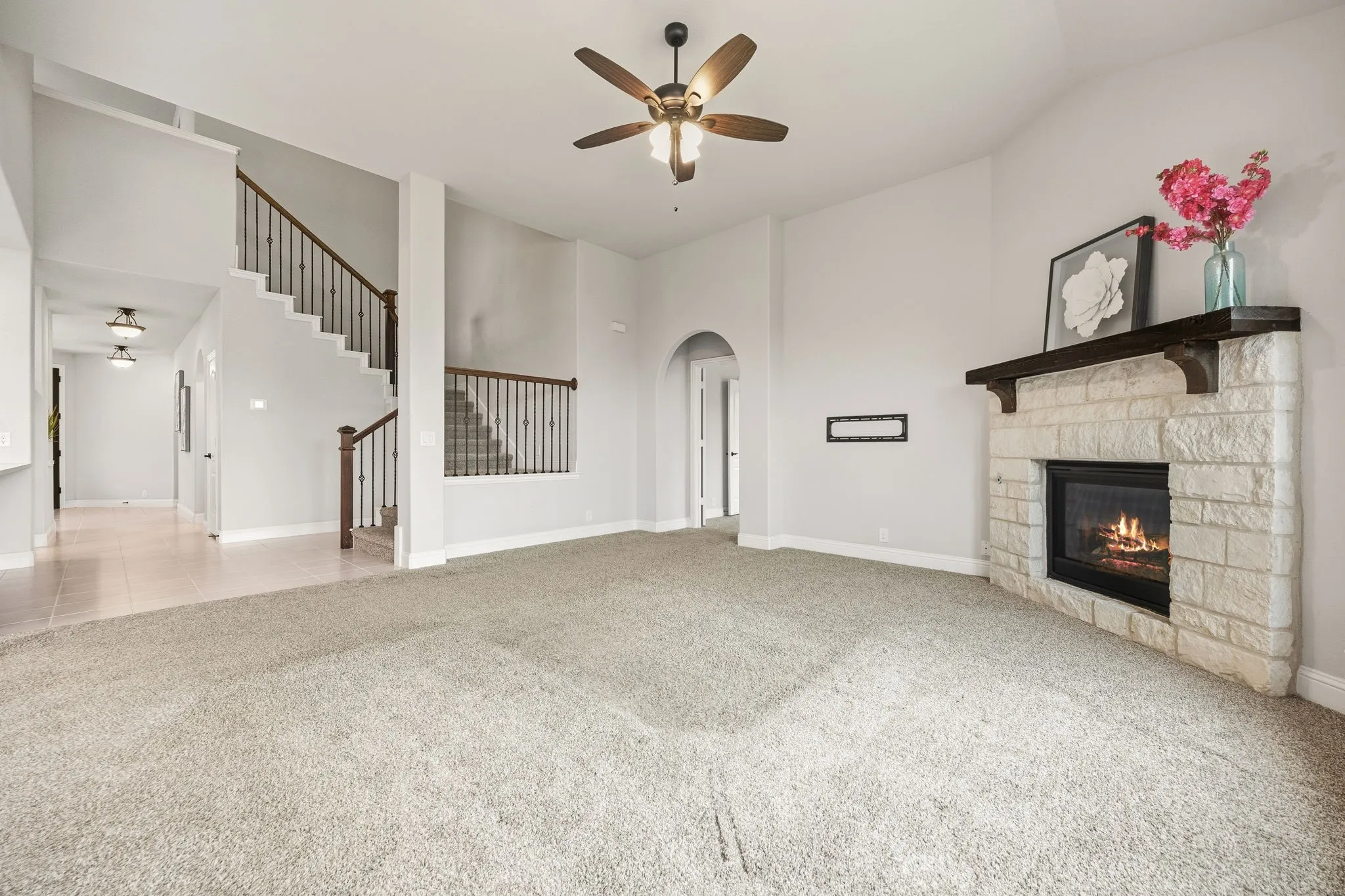 Stone surround fireplace with a wood mantel