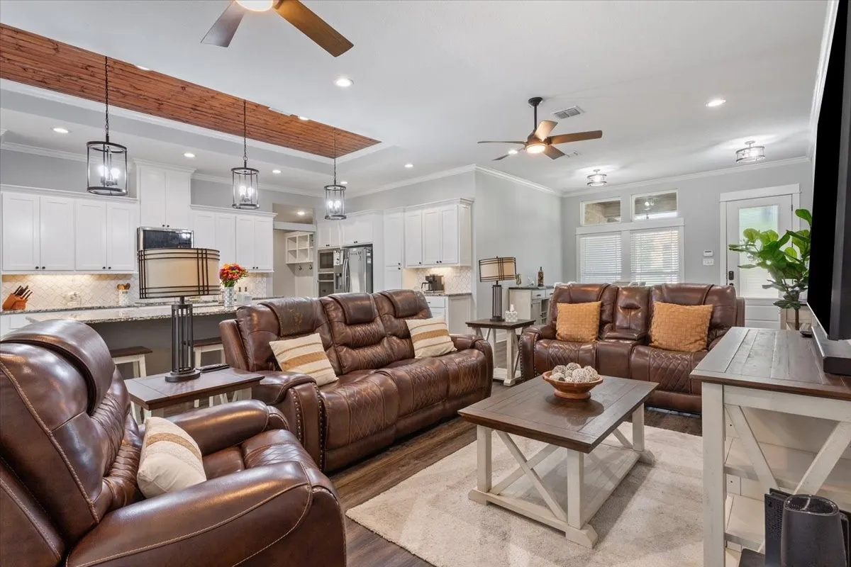 Open-concept living space featuring wood-finish flooring, recessed lighting, and ceiling fans
