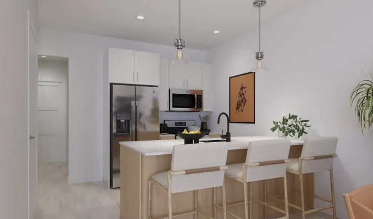 Kitchen featuring stainless steel appliances, a peninsula, hanging light fixtures, white cabinets, and a breakfast bar area