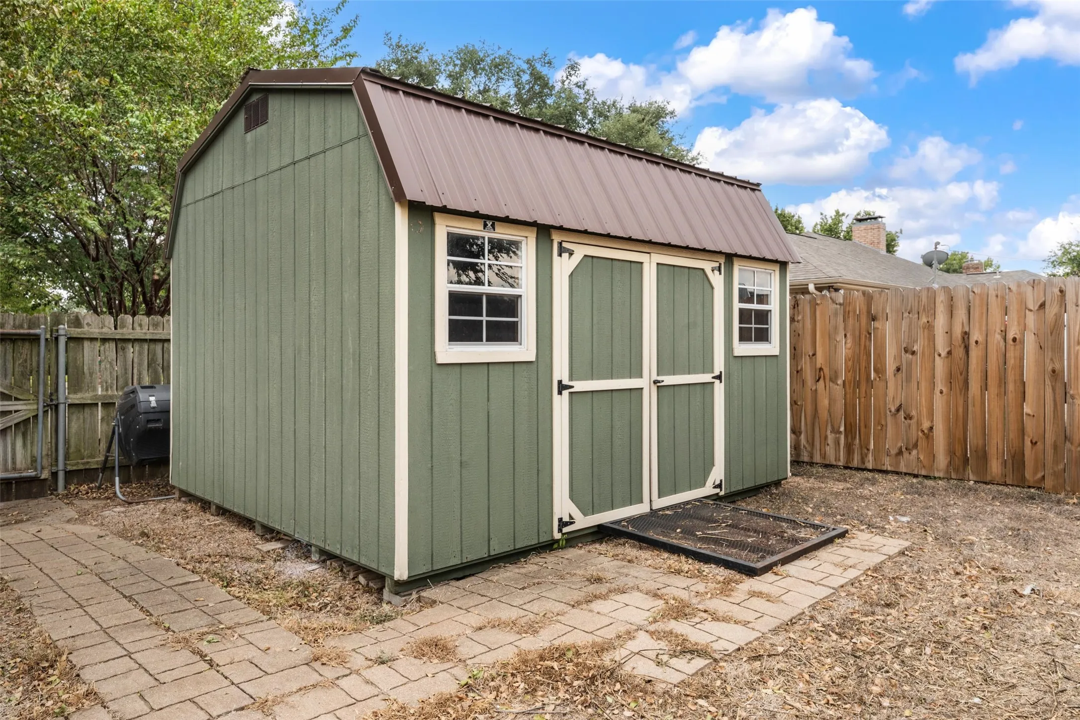 Detached shed featuring a gambrel roof and double entry doors