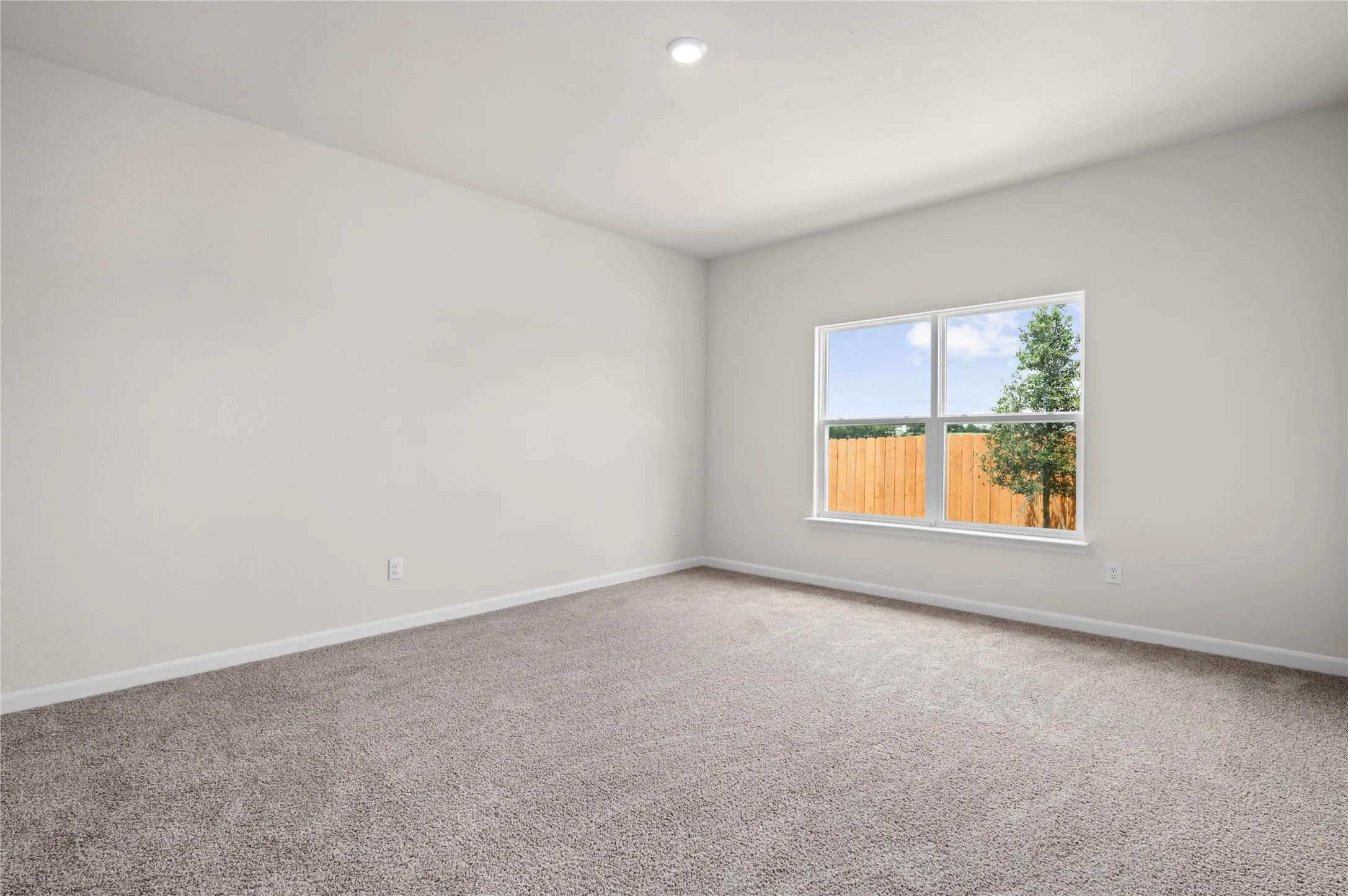 Carpeted spare room featuring baseboards and recessed lighting