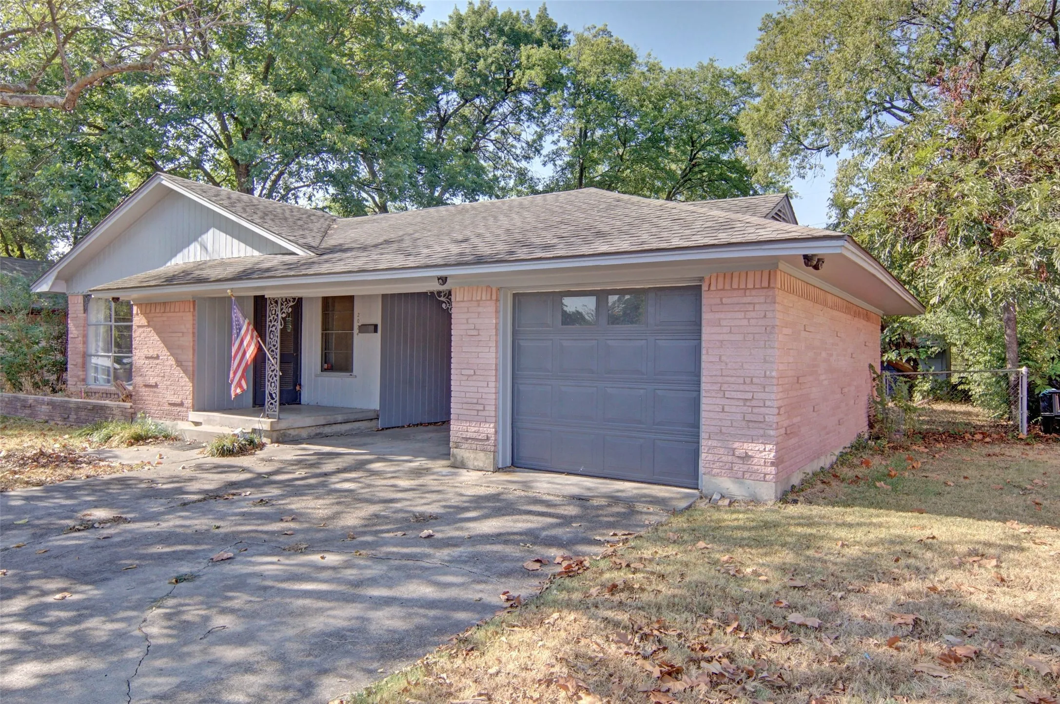 Brick exterior with a gabled roofline and attached garage