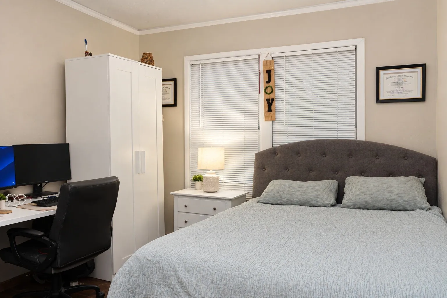 Window with blinds, light gray wall paint, dark wood-finish flooring, white crown molding, and white trim