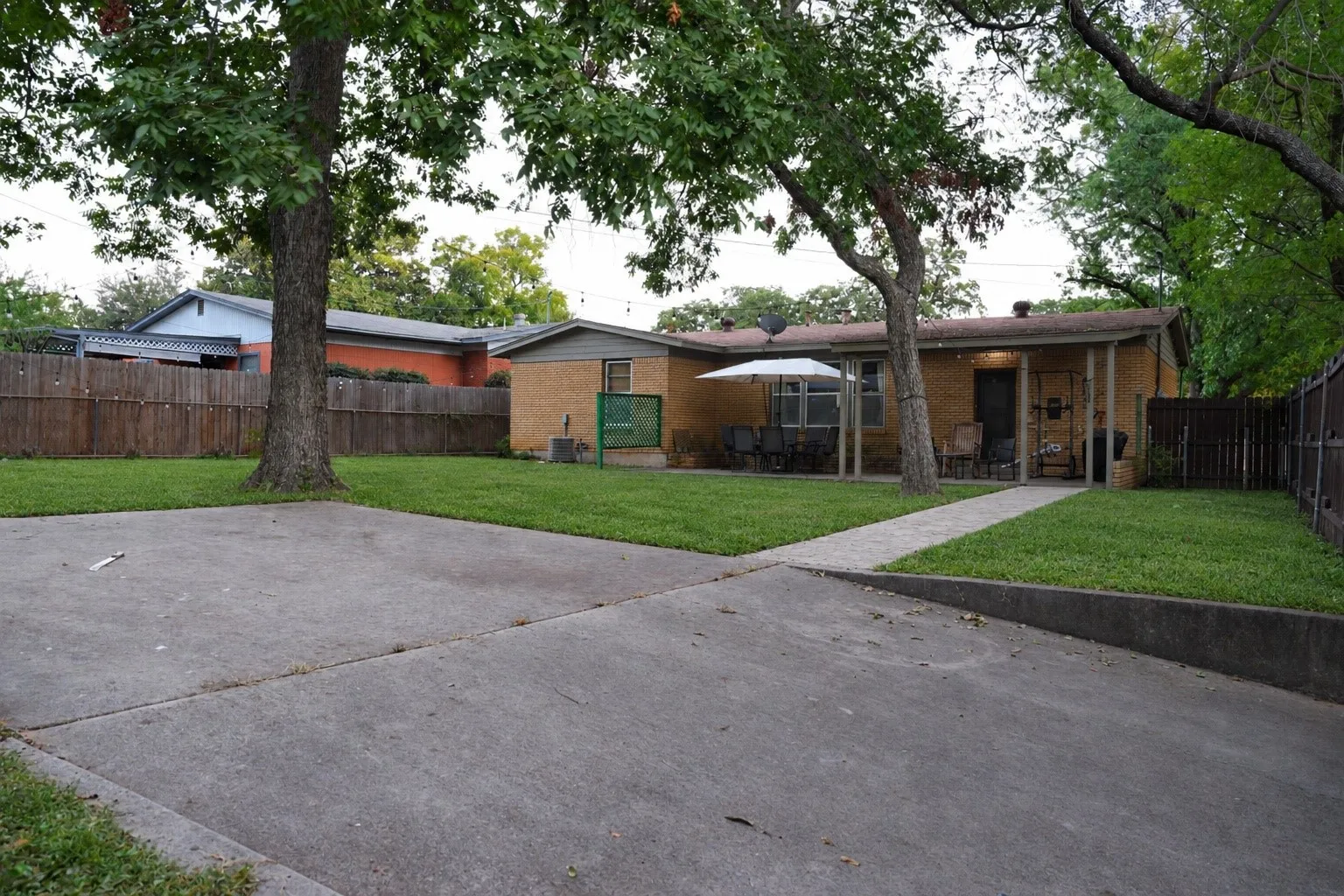 Concrete driveway with an integrated walkway leading to the front porch