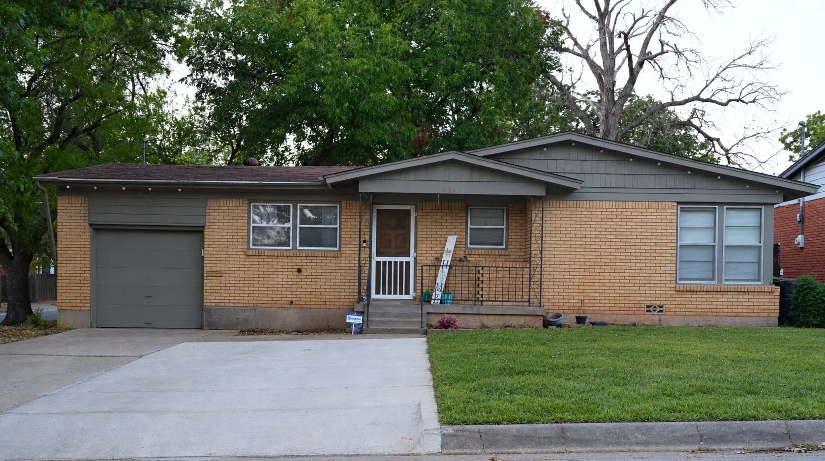 Brick exterior with a gabled roof and attached garage