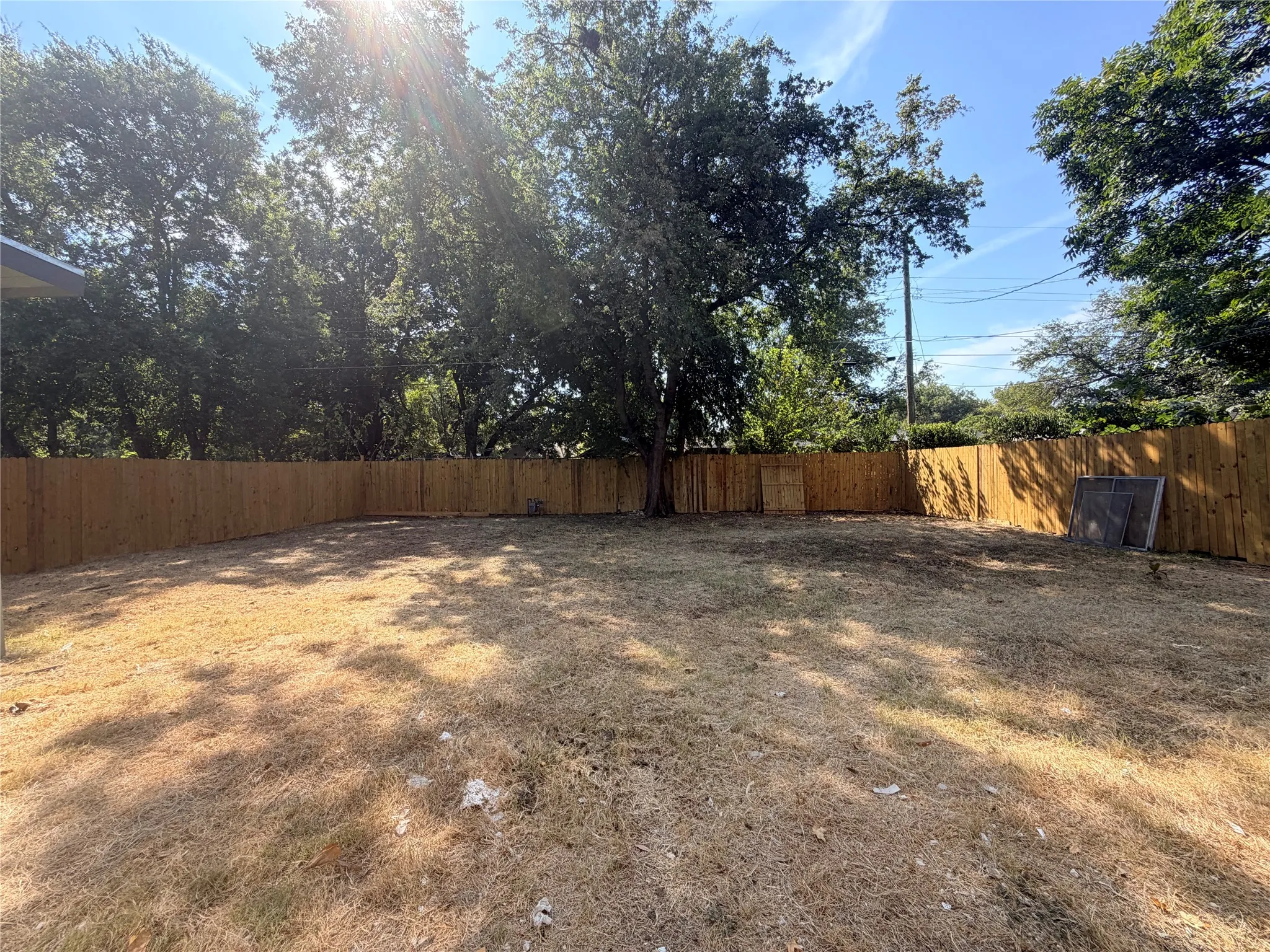 Expansive fenced yard with mature trees