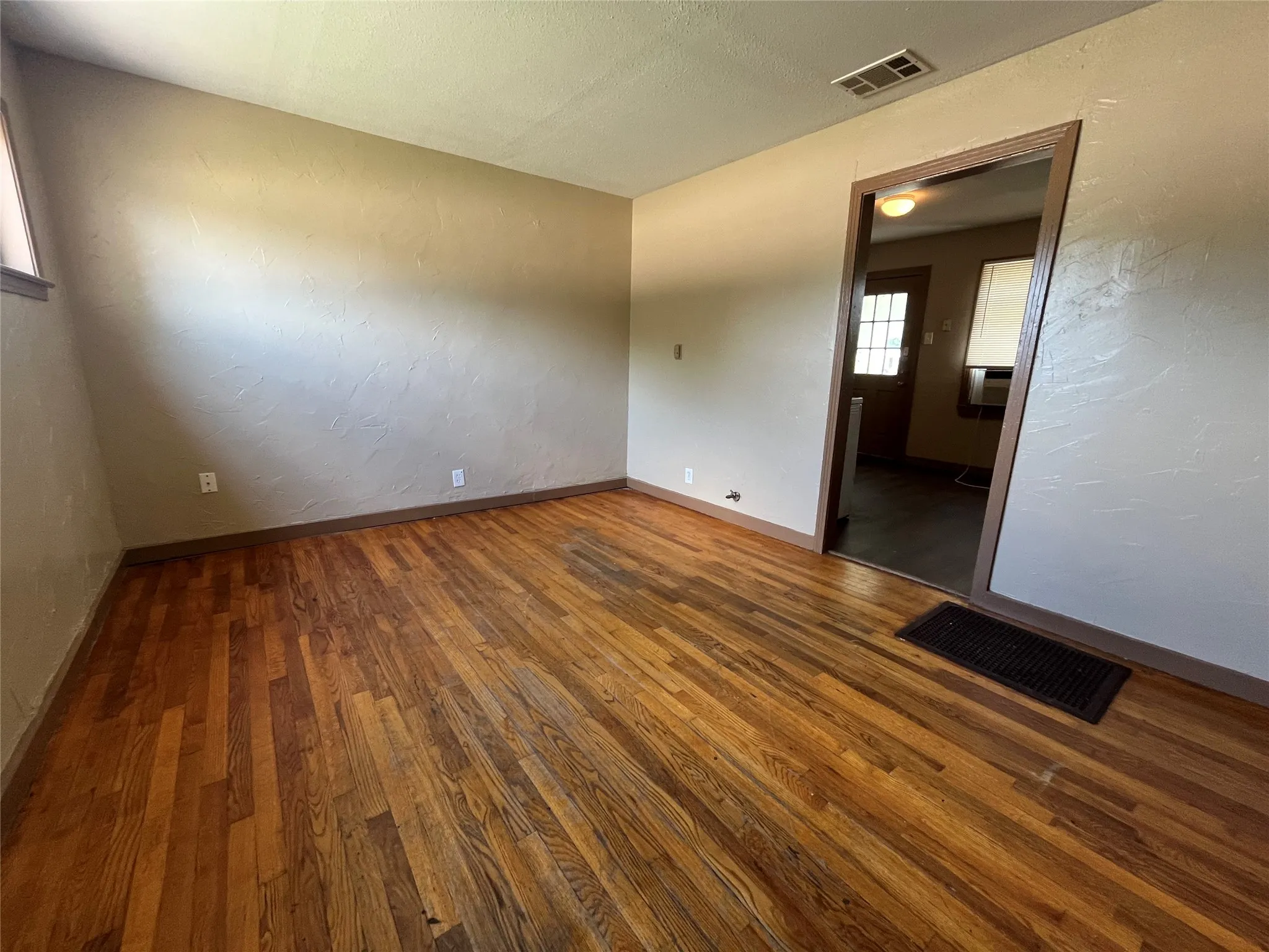 Unfurnished room featuring dark hardwood / wood-style flooring