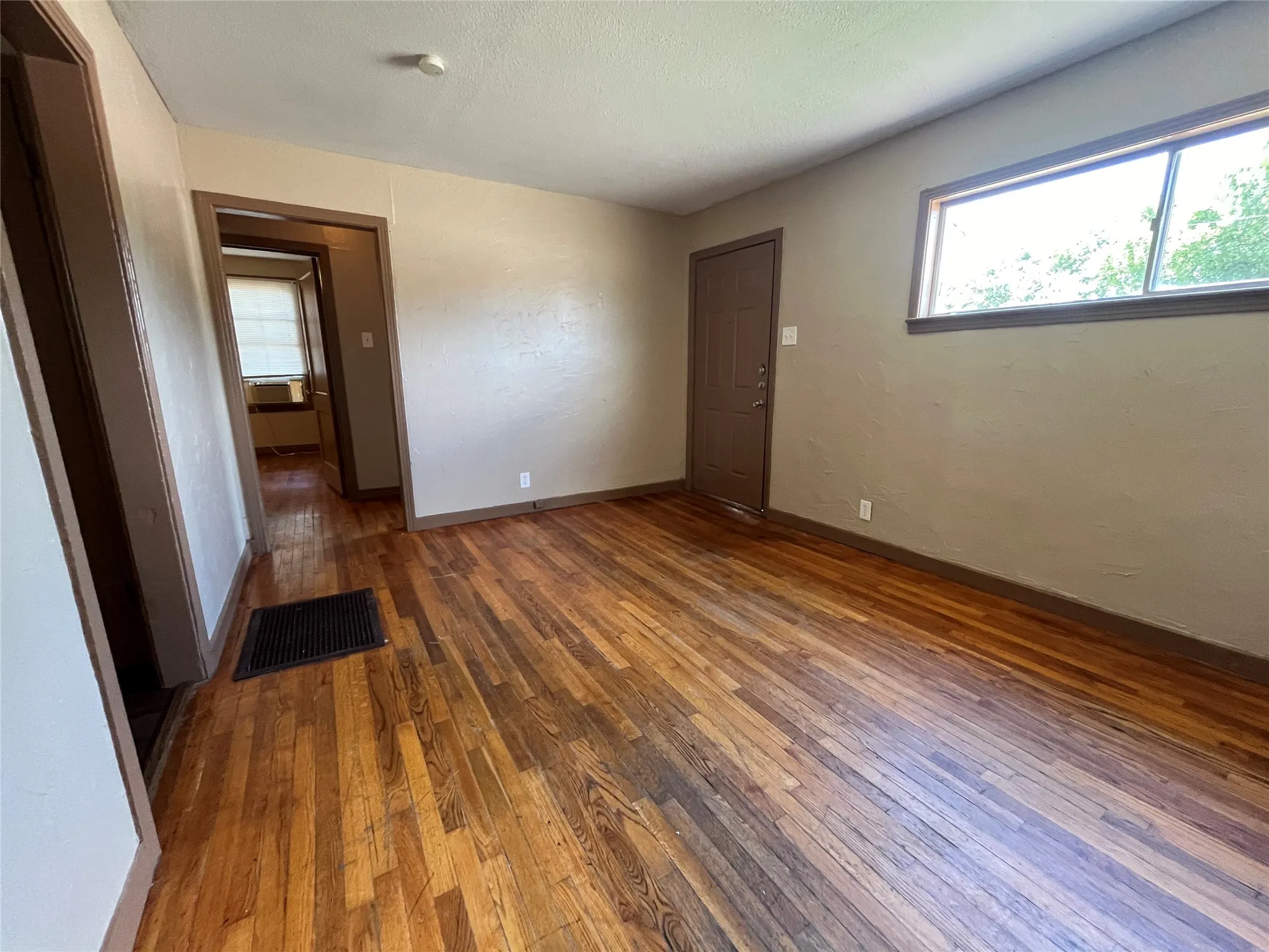 Unfurnished bedroom with dark wood-type flooring