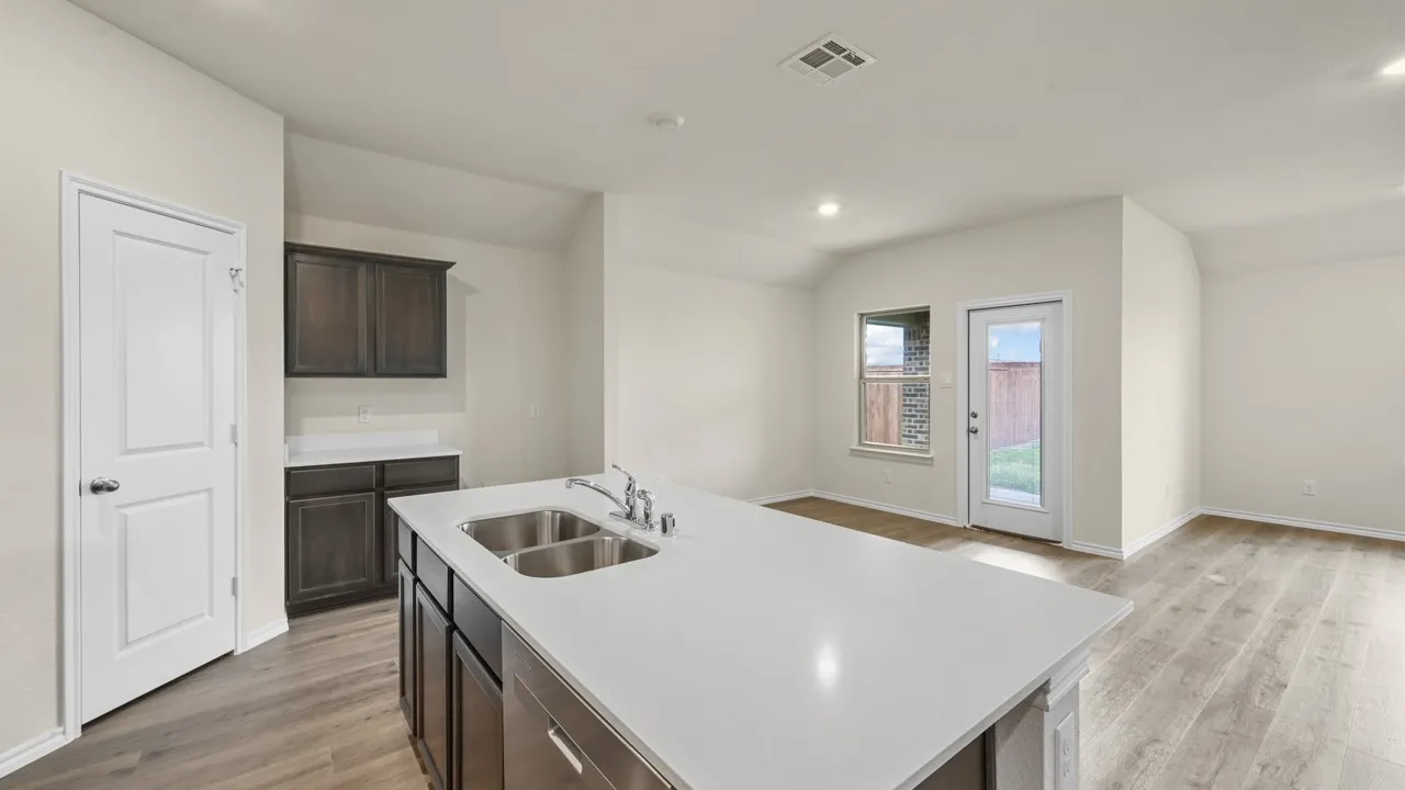 Central island with dual stainless steel sinks and a white countertop