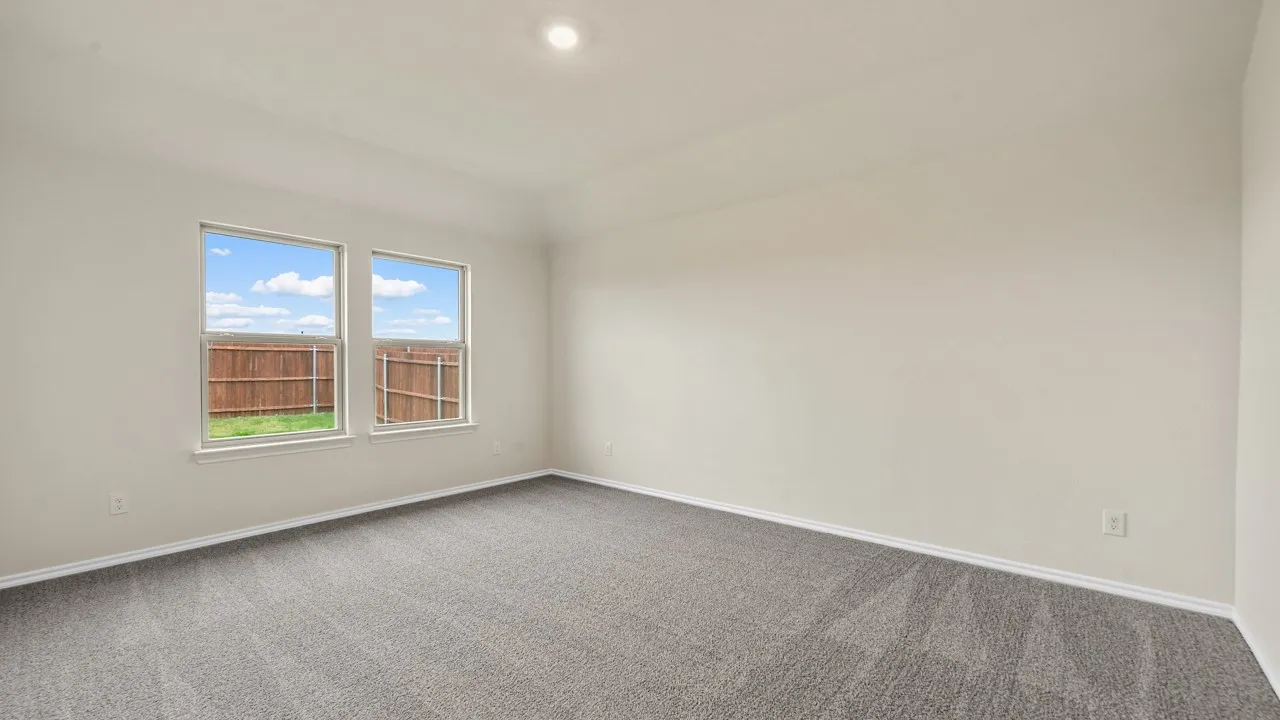 Neutral wall color, recessed ceiling lighting, light gray carpeting, and dual windows