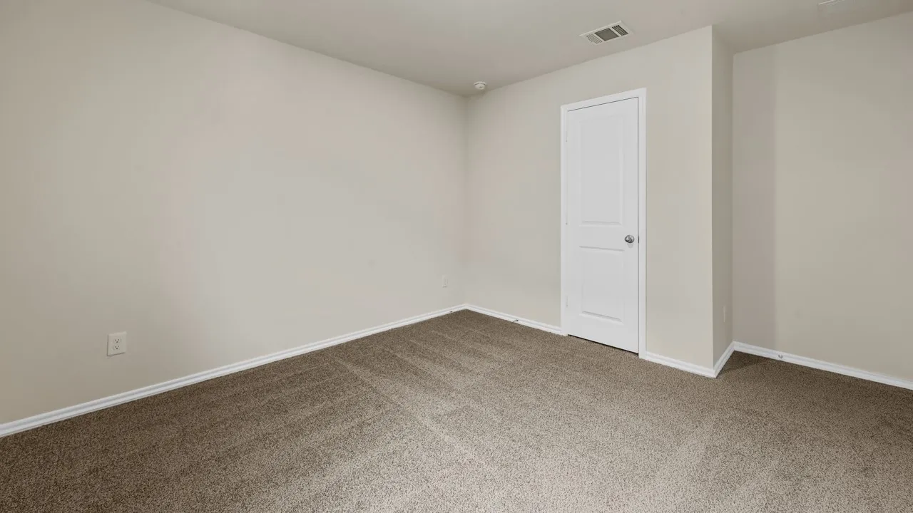 Neutral-toned walls, carpeted flooring, and white trim