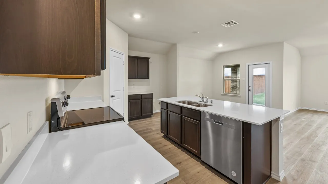 Kitchen featuring an island with double sinks, stainless steel dishwasher, white countertops, dark wood-finish cabinetry, and wood-finish flooring