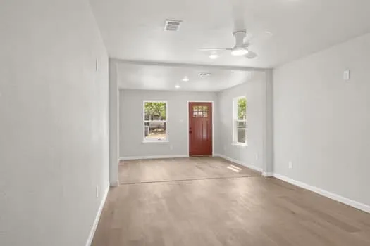 Open-concept living space featuring wood-finish flooring, recessed lighting, and a ceiling fan