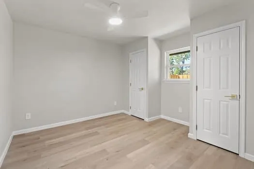 Light wood-finish flooring with white trim