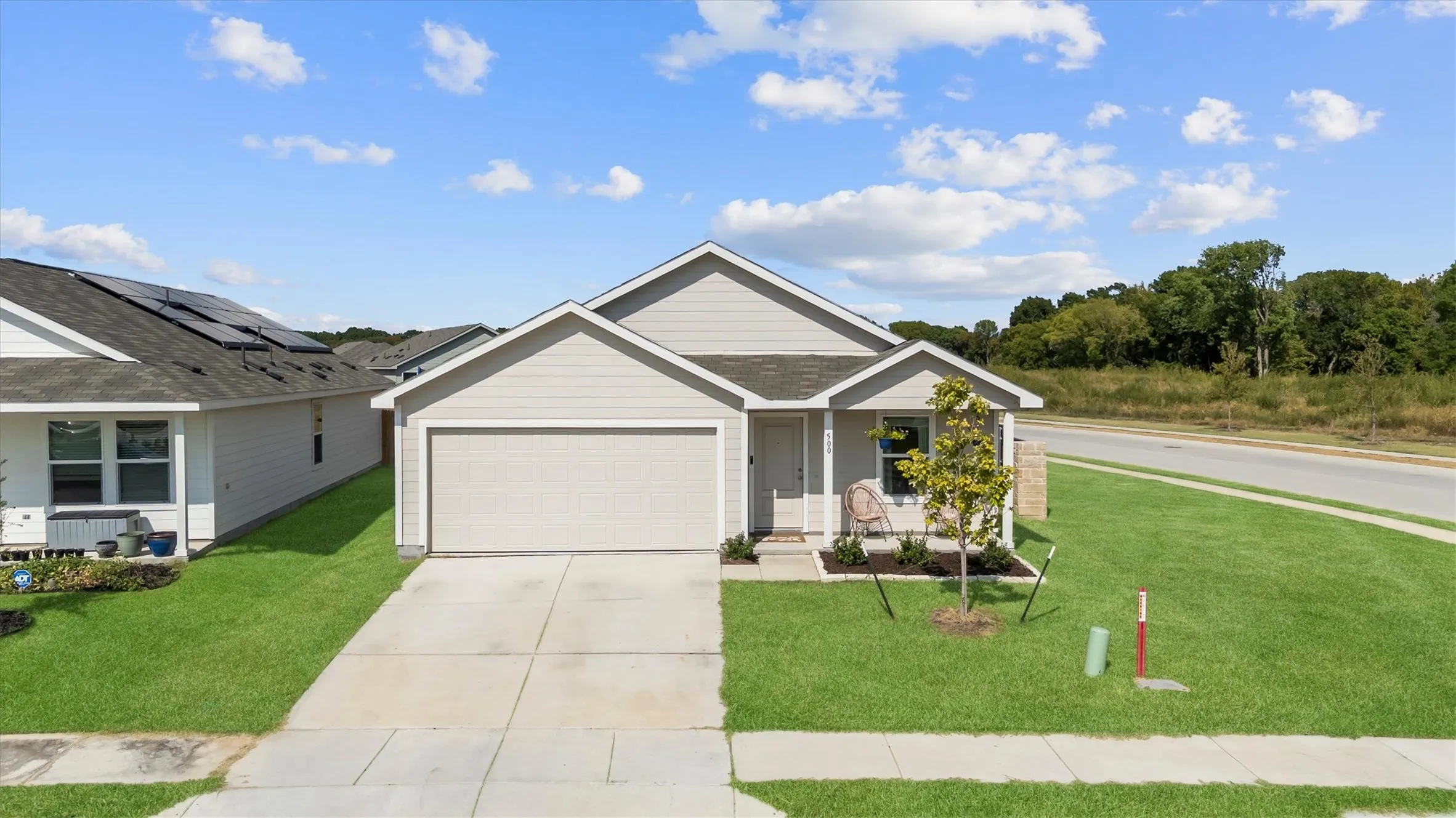 Front of home on a corner lot across from one of the community pools.