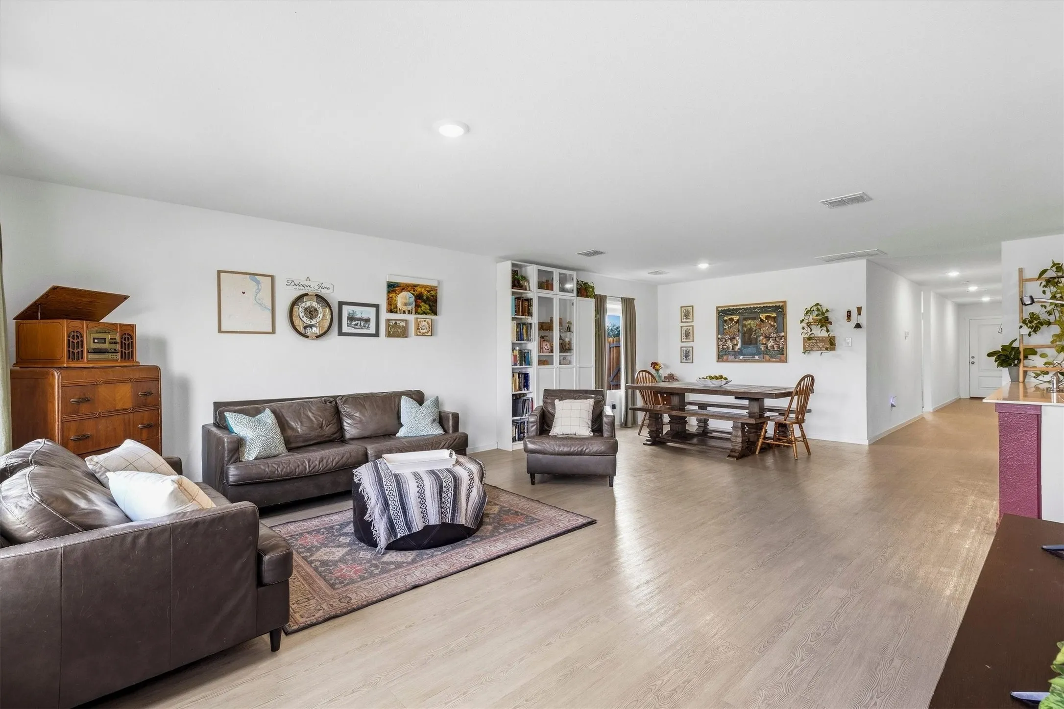 Living room open to dining and kitchen.