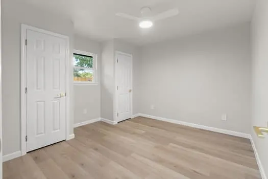 Light wood-finish flooring with white trim
