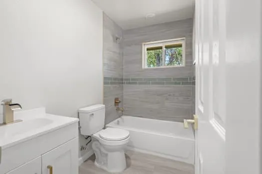 White vanity with a single basin sink and brushed nickel faucet