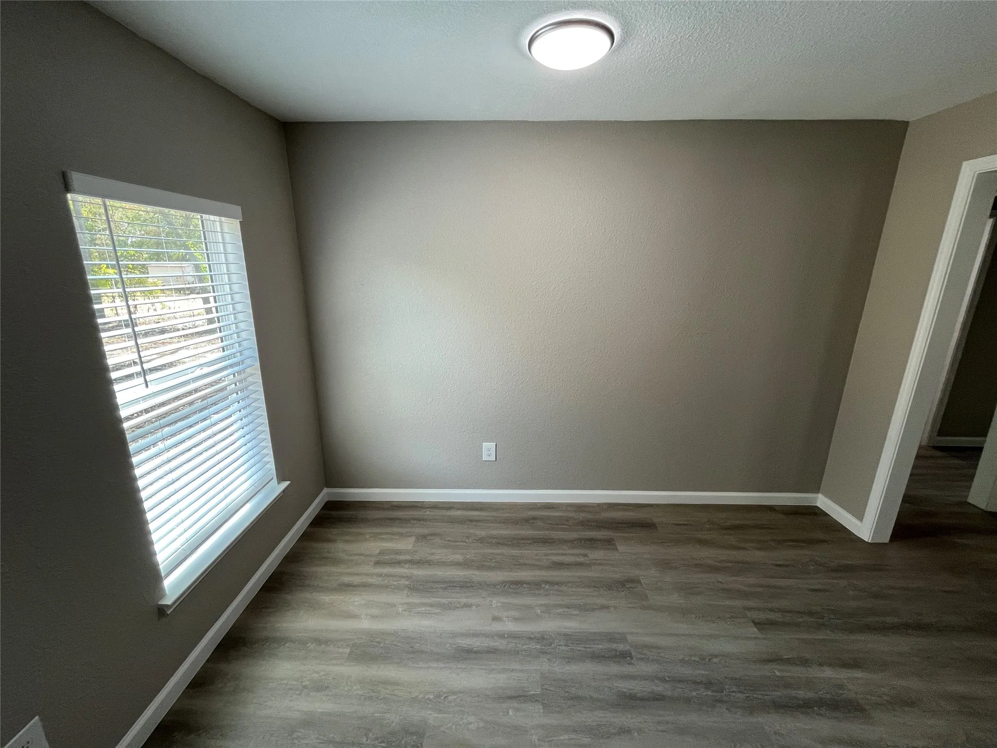 Wood-finish flooring with neutral wall tones and white trim