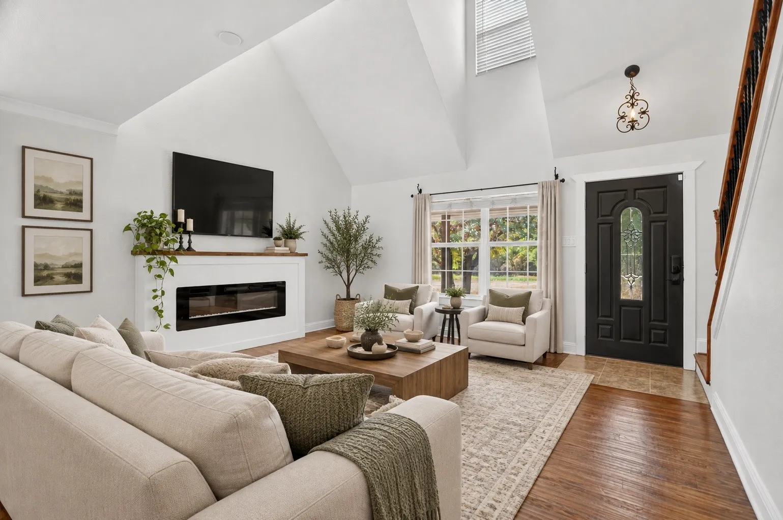 Vaulted ceiling, hardwood flooring, integrated fireplace, decorative entry door, and skylight. Virtually staged using Ai.