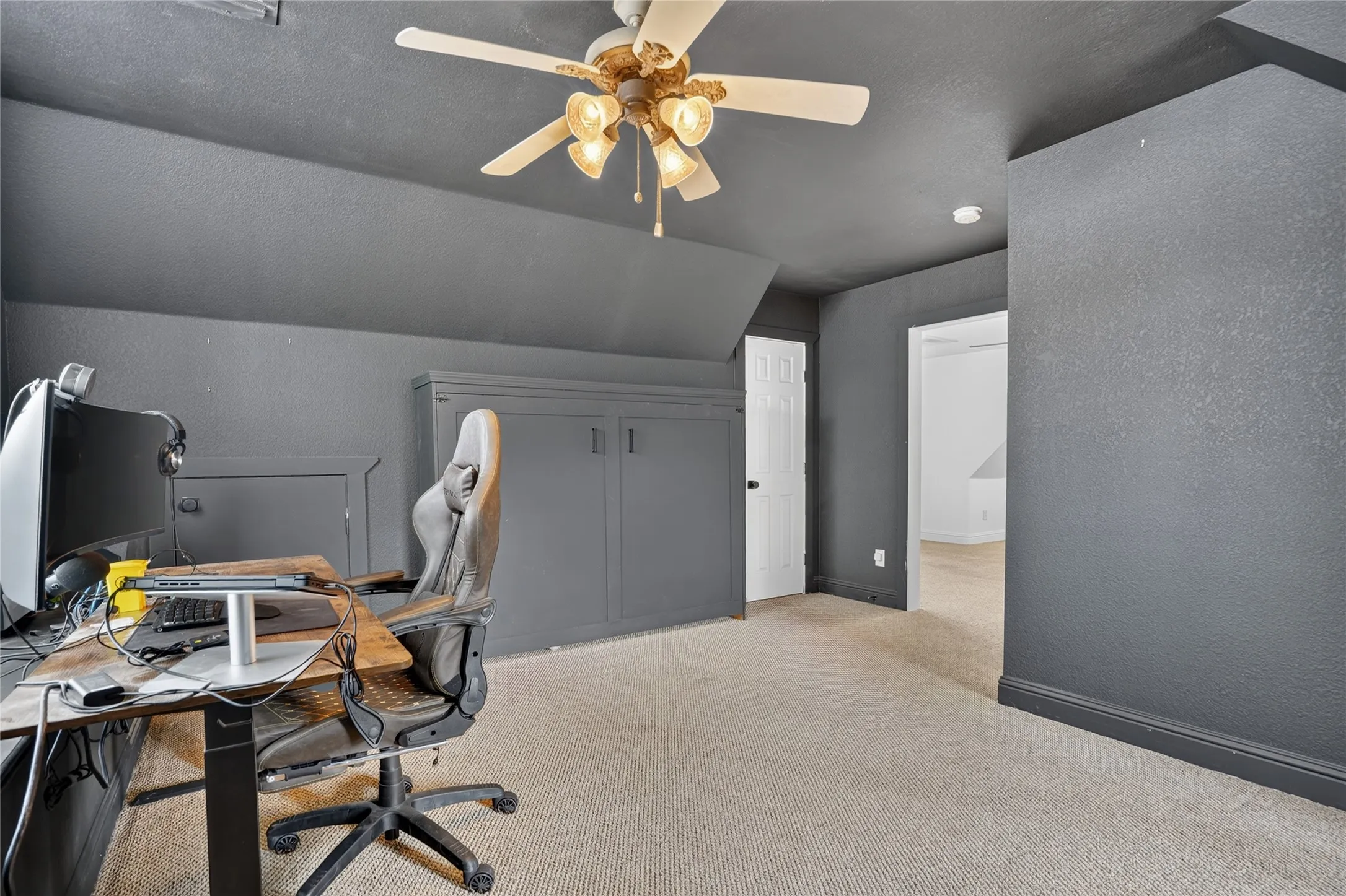 Carpet flooring and a ceiling fan with integrated lighting