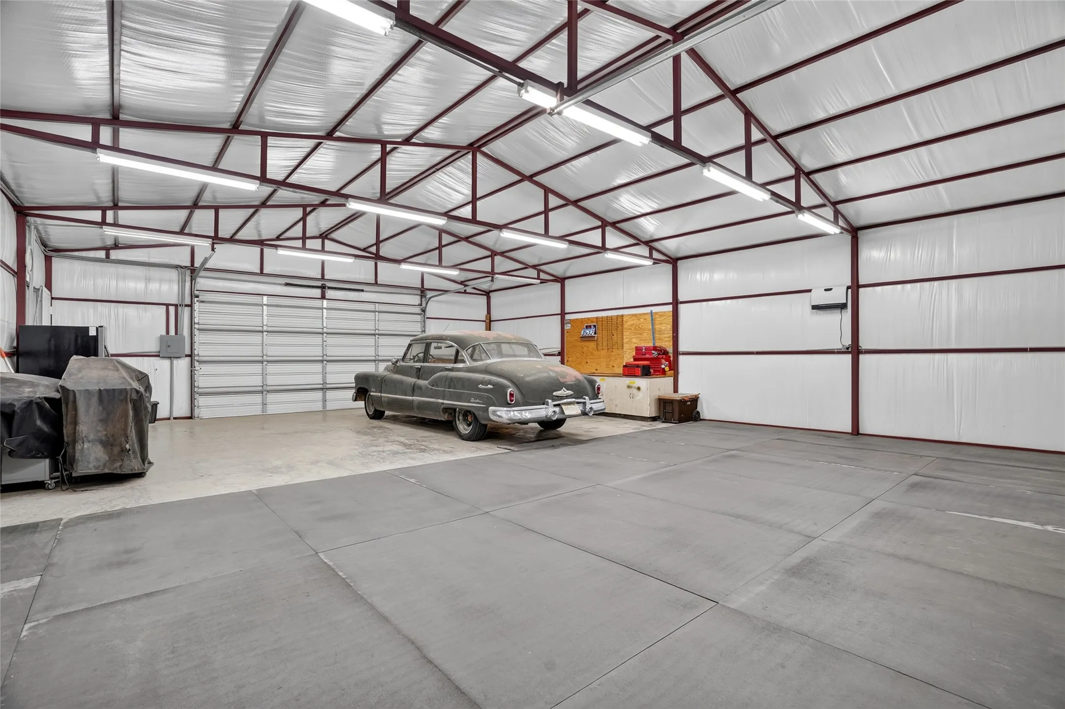 Spacious metal building with a high-pitched roof and exposed support beams